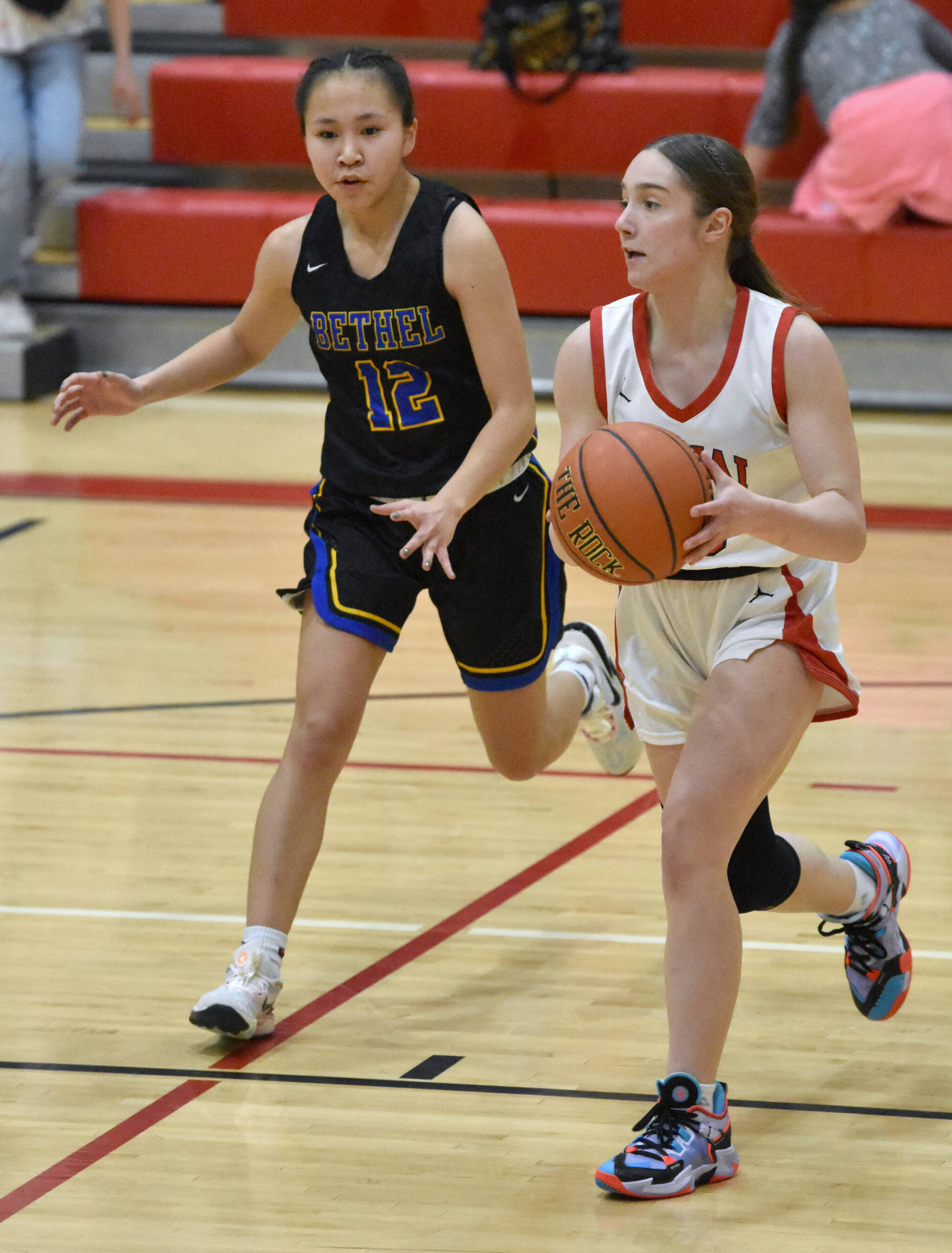 Kenai Central’s Sierra Hershberger keeps the ball from Bethel’s Kyana Harpak on Wednesday, Jan. 10, 2024, at Kenai Central High School in Kenai, Alaska. (Photo by Jeff Helminiak/Peninsula Clarion)