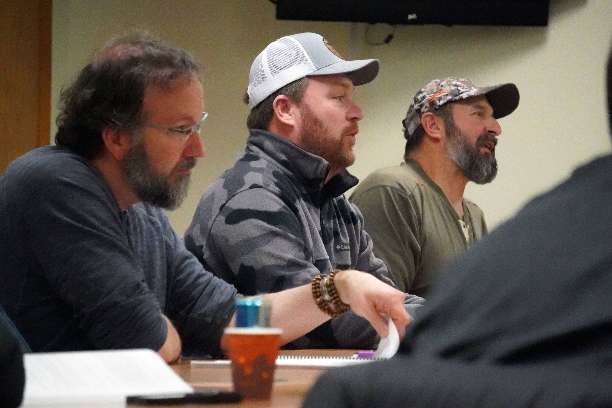 Cook Inlet Coordinator for the Department of Fish and Game Matt Miller and Kenai/Soldotna Fish and Game Advisory Committee Members Greg Springer and Monte Roberts discuss proposals to the the State Board of Fisheries at a committee meeting at Cook Inlet Aquaculture Association in Kenai, Alaska, on Monday, Jan. 15, 2024. (Jake Dye/Peninsula Clarion)