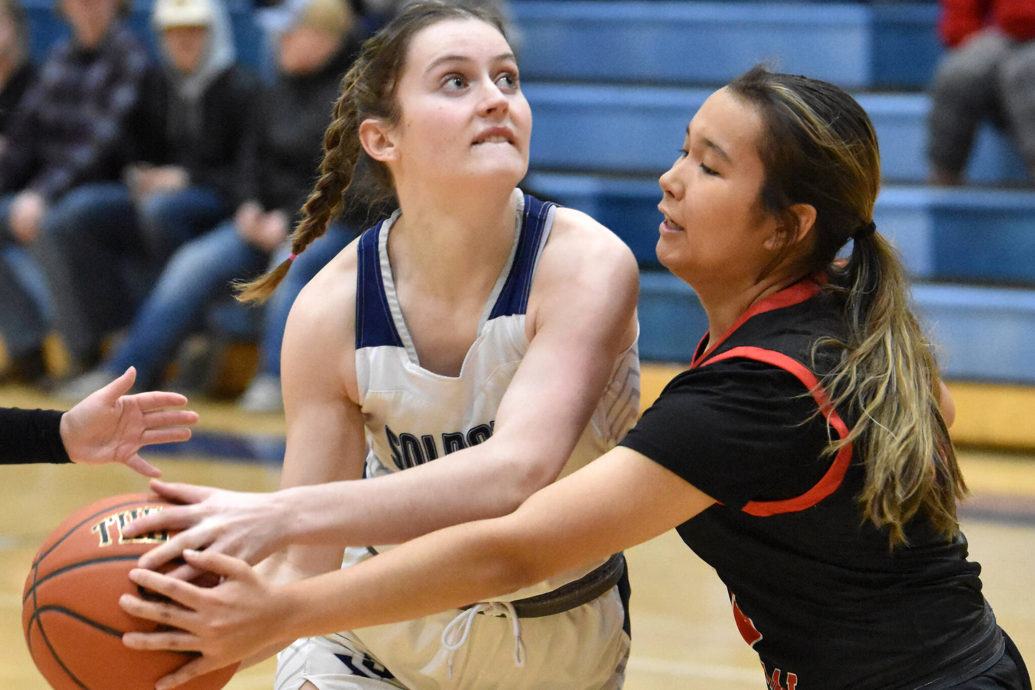 Soldotna's Kaytlin McAnelly drives on Kenai Central's Alex Nelson at the Revolution Sport and Spine Therapy Al Howard Shootout on Thursday, Jan. 25, 2024, at Soldotna High School in Soldotna, Alaska. (Photo by Jeff Helminiak/Peninsula Clarion)
