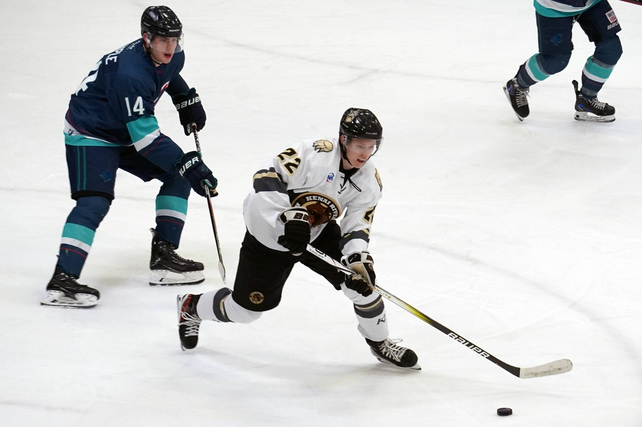 Kenai River’s Roope Tuomioksa works to keep the puck from Anchorage’s Jackson Stimple moments before scoring a goal at the Soldotna Regional Sports Complex in Soldotna, Alaska, on Friday, Jan. 25, 2024. (Jake Dye/Peninsula Clarion)