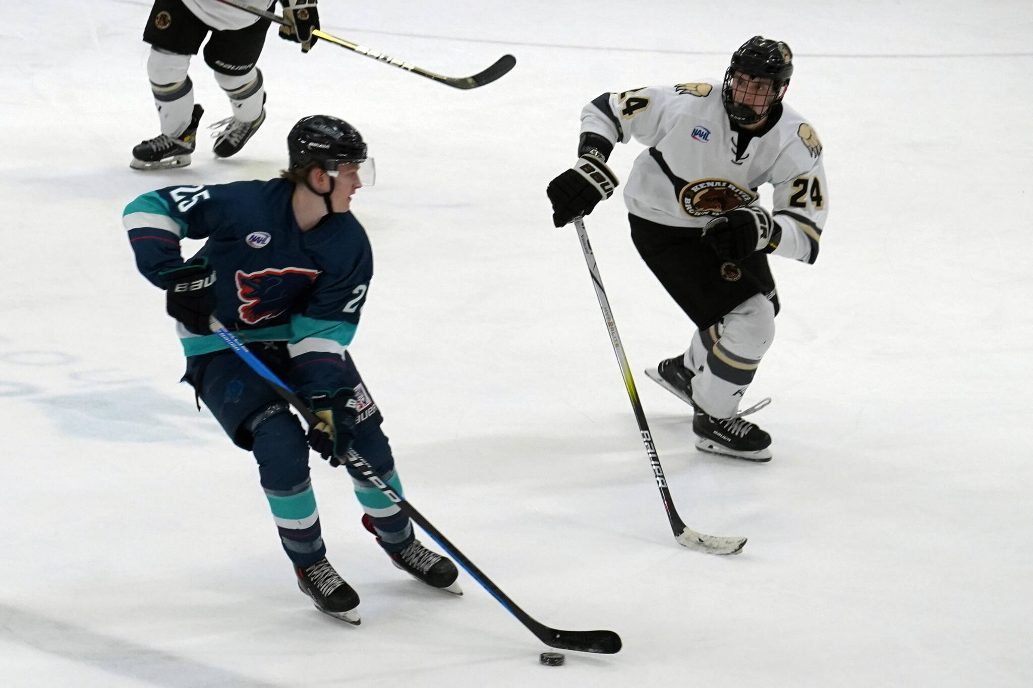 Anchorage’s Jack Darby works to keep the puck from Kenai River’s Luke Hause at the Soldotna Regional Sports Complex in Soldotna, Alaska, on Friday, Jan. 25, 2024. (Jake Dye/Peninsula Clarion)