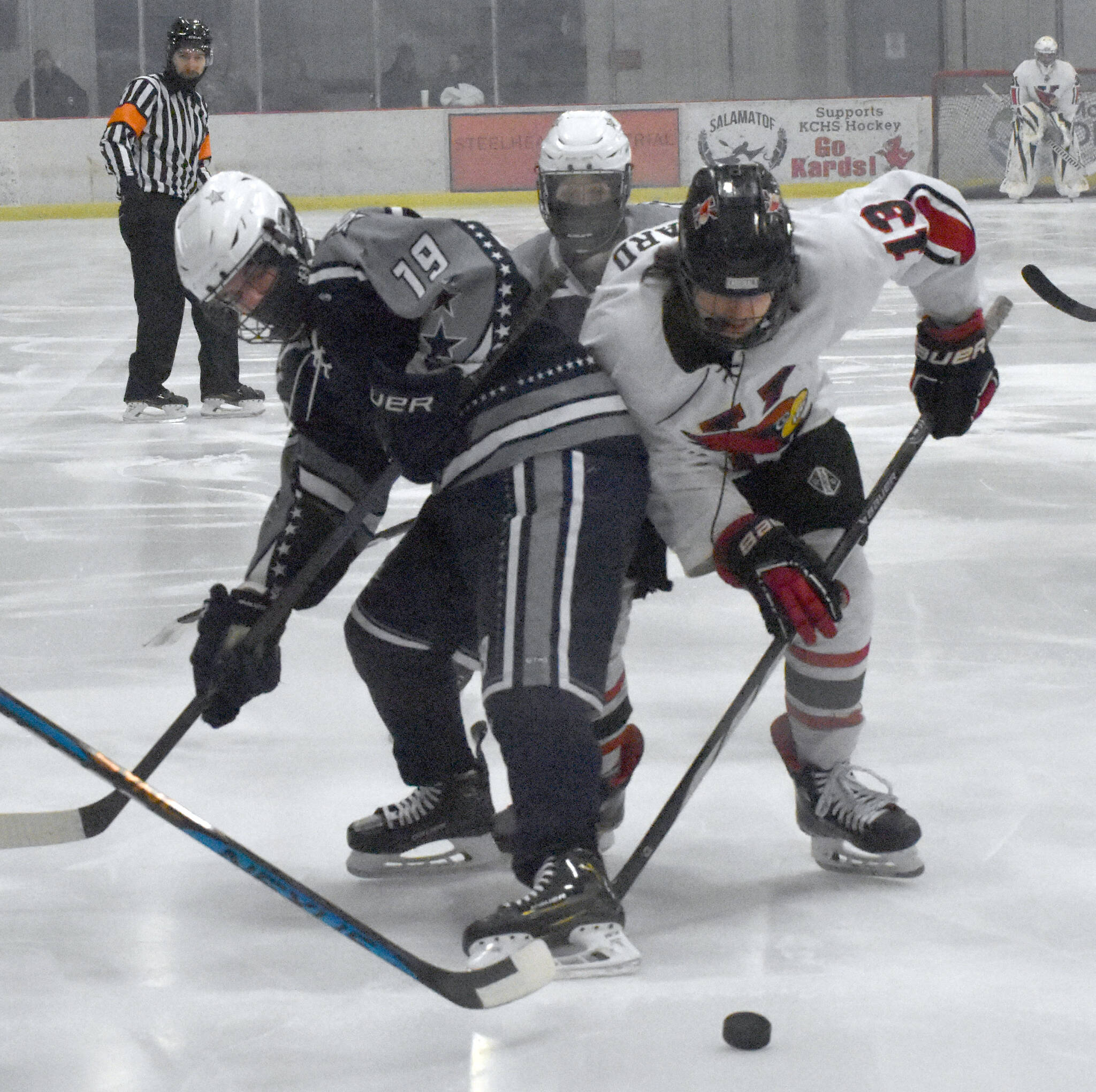 Photo by Jeff Helminiak/Peninsula Clarion
Soldotna’s Marshall Deraeve and Kenai Central’s Will Howard battle for the puck Friday at the Kenai Multi-Purpose Facility.