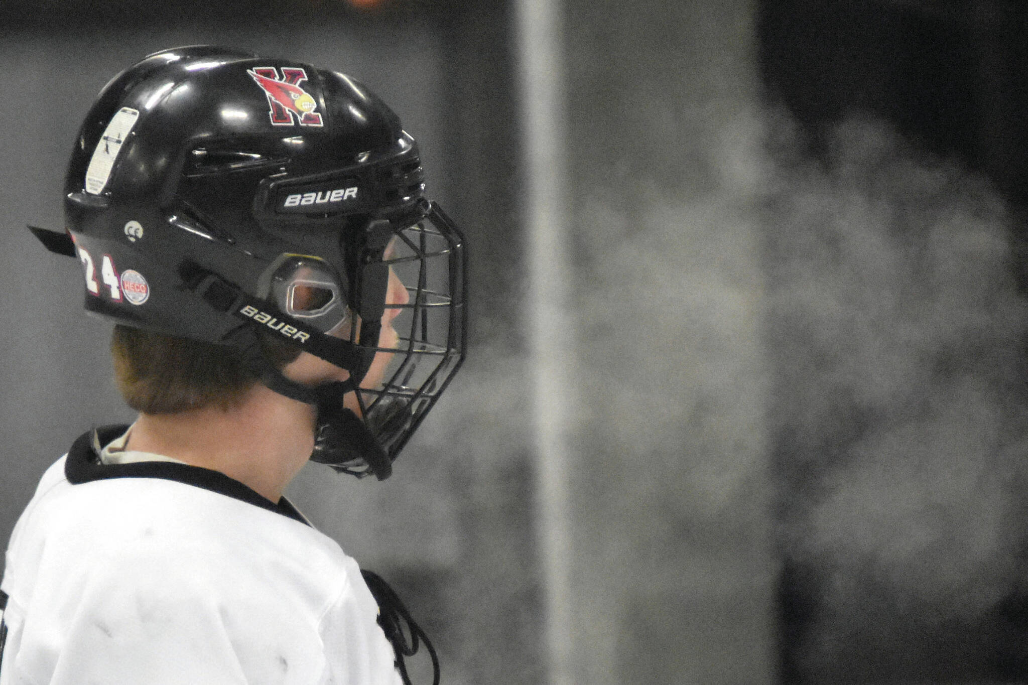 Kenai Central’s Avery Martin exhales into the frigid air Friday, Jan. 26, 2024, at the Kenai Multi-Purpose Facility in Kenai, Alaska. (Photo by Jeff Helminiak/Peninsula Clarion)