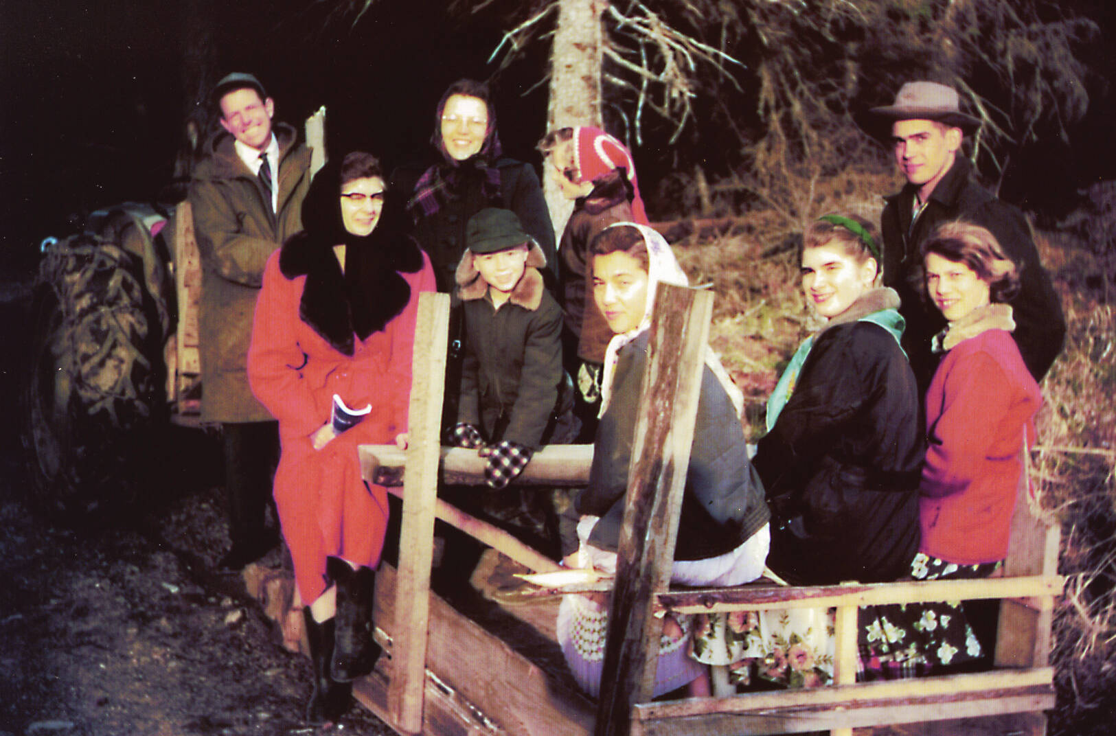 Members of the Keeler family and some Anchor Point church members get a ride on Jimmy Elliot’s “mud sled” on the way to services at the Elliot home, circa 1956. Lorna Keeler is sitting on the far-left side of the sled. April Keeler is the middle girl of the trio sitting in back, and Larry Keeler is standing behind those girls. (Photo courtesy of the Pratt Museum)