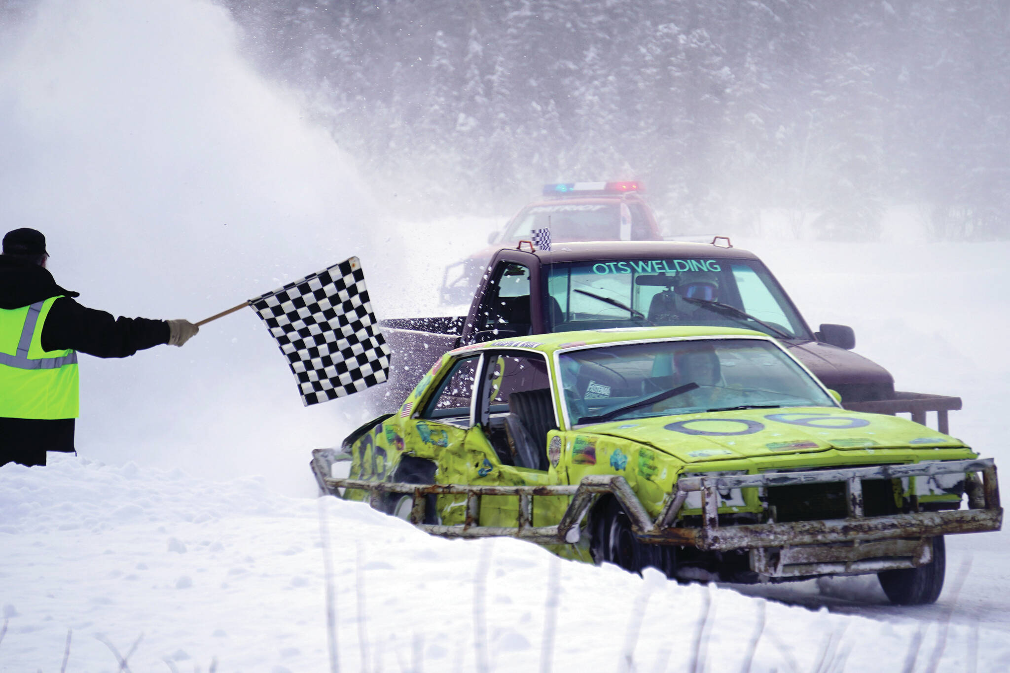 Ralph Mills clears the finish line in first place during the Men’s Main Event race as part of Kenai Peninsula Ice Racing at the Decanter Inn in Kasilof on Sunday. (Jake Dye/Peninsula Clarion)