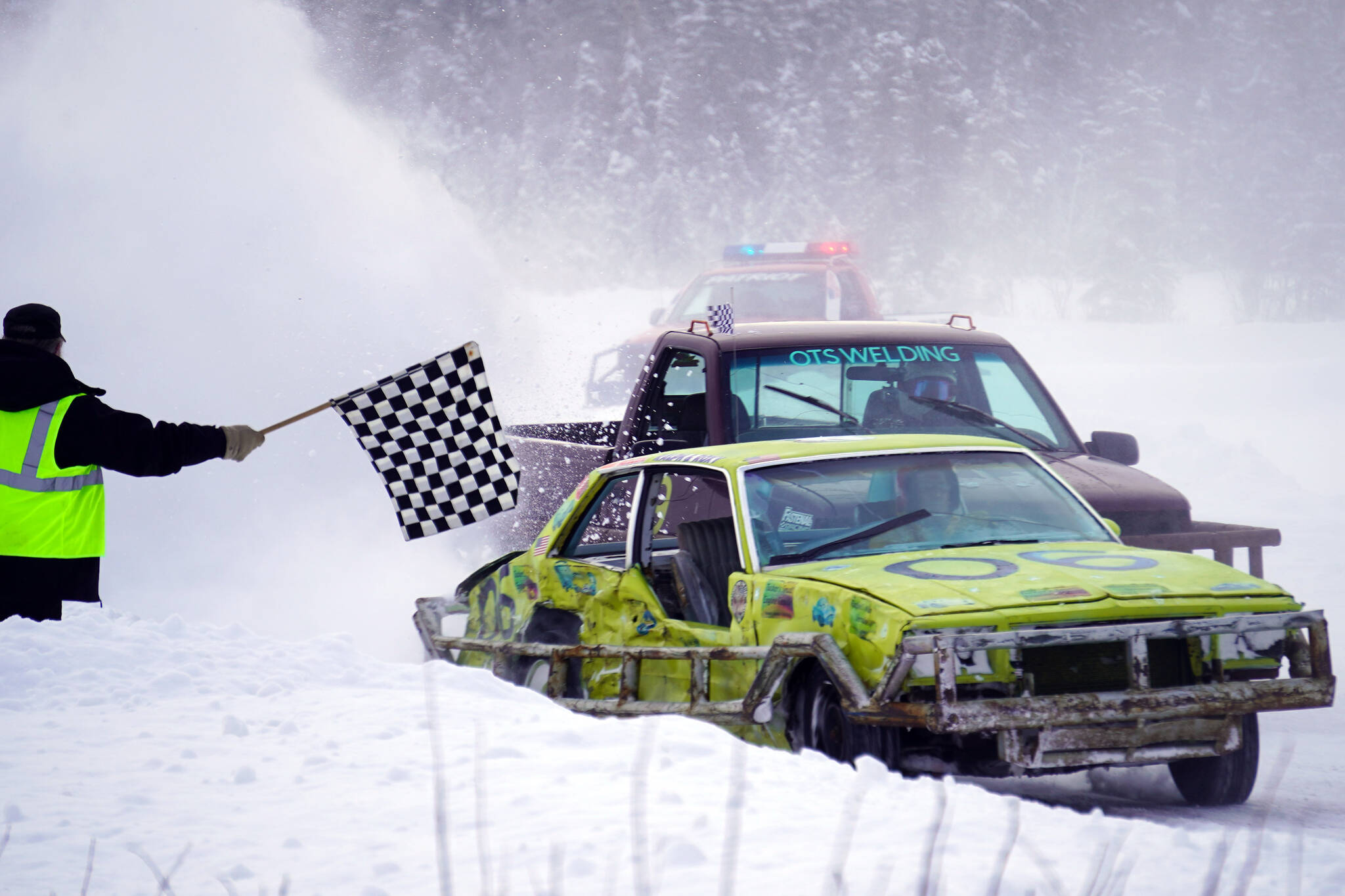 Ralph Mills clears the finish line in first place during the Men’s Main Event race as part of Kenai Peninsula Ice Racing at the Decanter Inn in Kasilof, Alaska, on Sunday, Feb. 4, 2024. (Jake Dye/Peninsula Clarion)