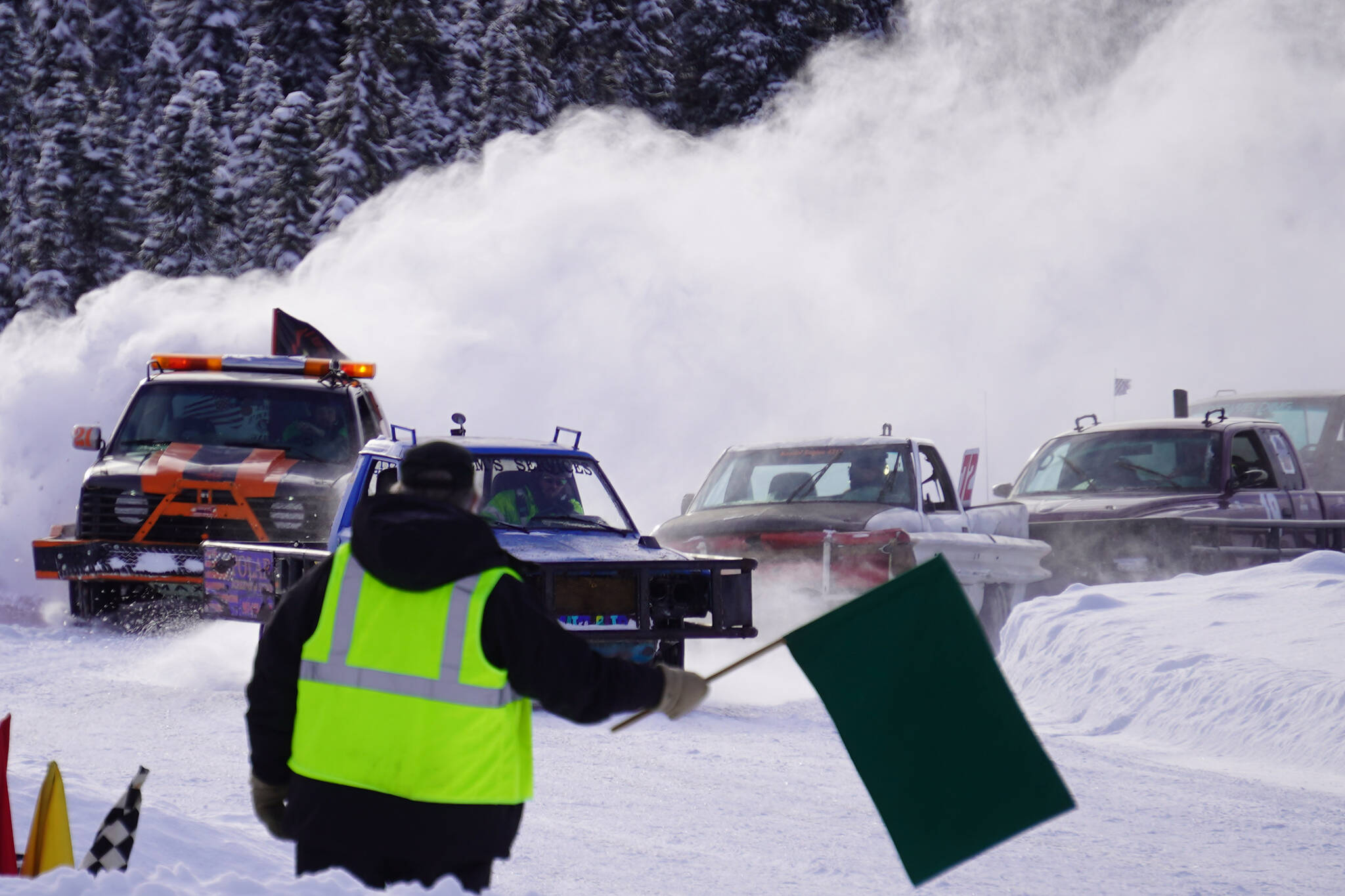 A tight pack of vehicles round the bend to complete a lap during Kenai Peninsula Ice Racing at the Decanter Inn in Kasilof, Alaska, on Sunday, Feb. 4, 2024. (Jake Dye/Peninsula Clarion)