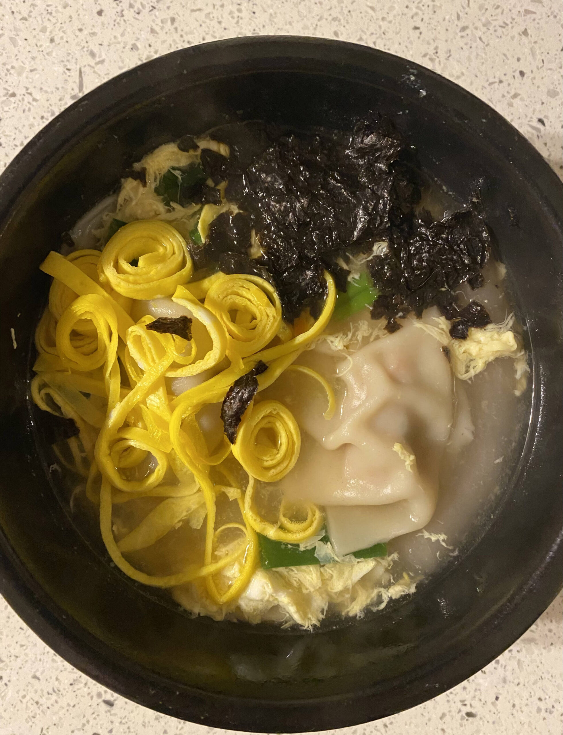 Meat- and vegetable-filled dumplings, fried eggs and nori stew in hot meat broth in this recipe for mandu-guk, or dumpling soup. (Photo by Tressa Dale/Peninsula Clarion)