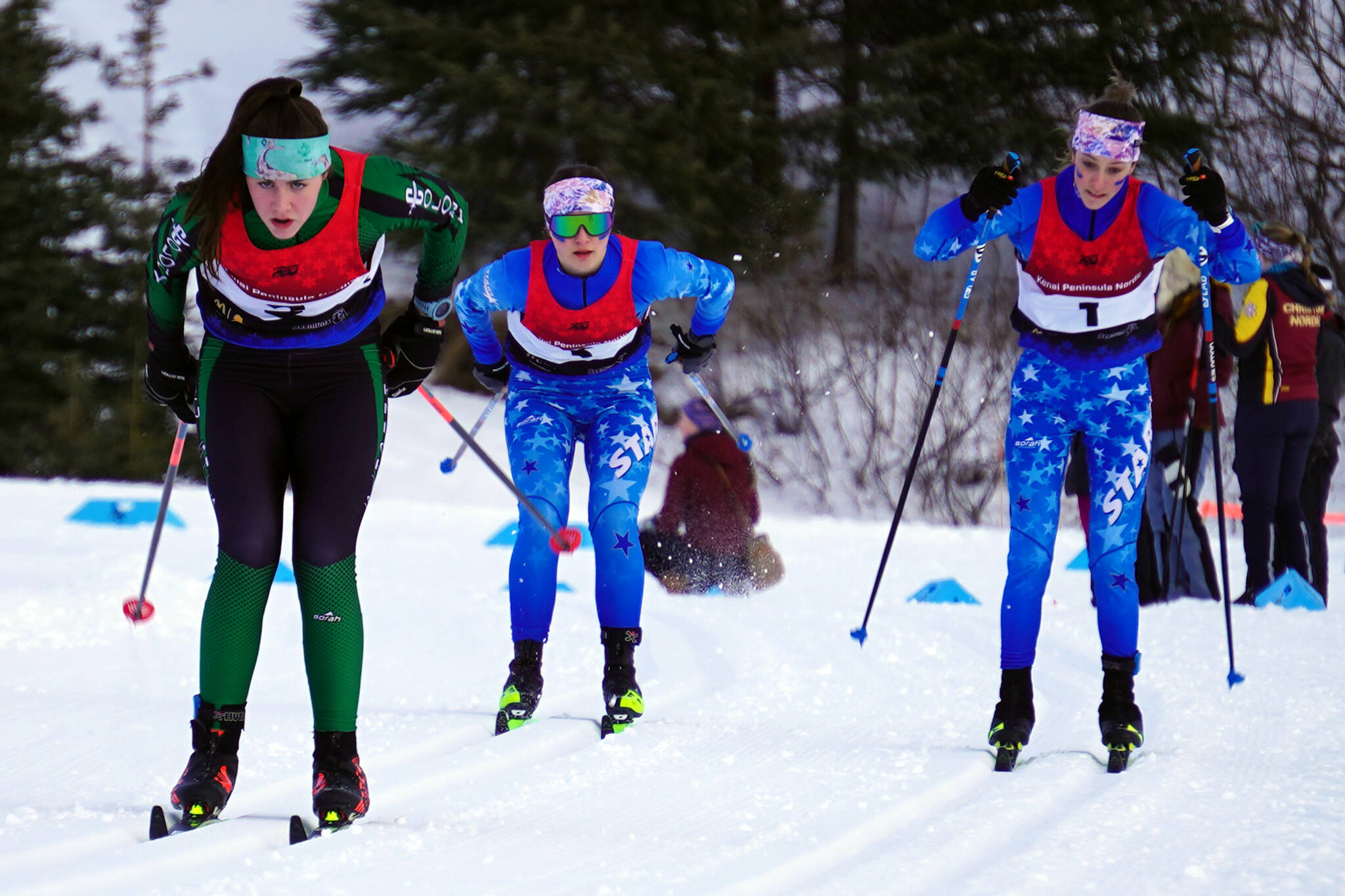 Colony's Elliot Sensabaugh leads Soldotna's Ariana Cannava and Tania Boonstra early during the Region III Girls 7.5K Classic Race at Tsalteshi Trails near Soldotna, Alaska, on Saturday, Feb. 10, 2024. (Jake Dye/Peninsula Clarion)