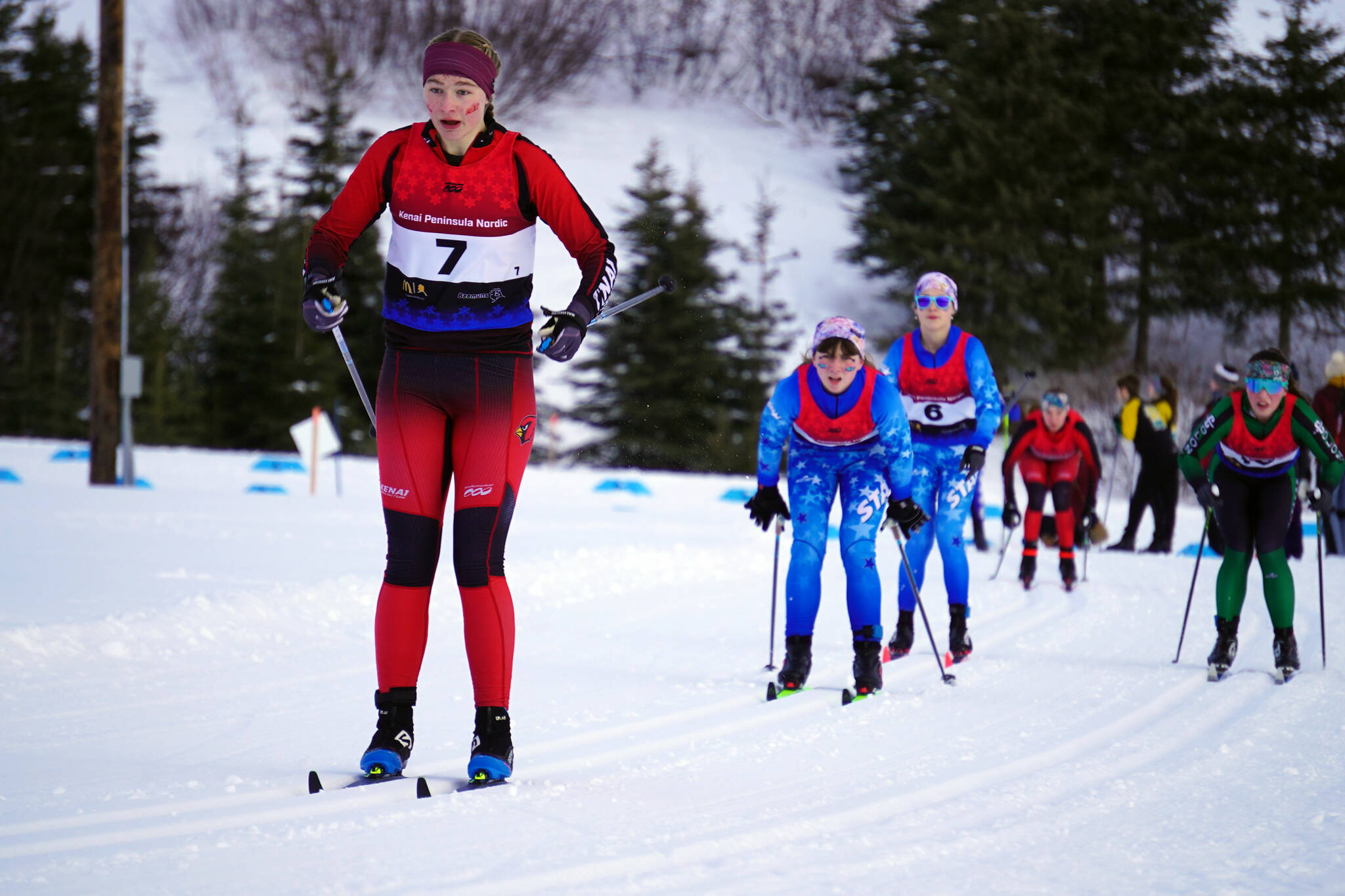 Kenai Central’s Emily Moss leads a pack of skiers early during the Region III Girls 7.5K Classic Race at Tsalteshi Trails near Soldotna, Alaska, on Saturday, Feb. 10, 2024. (Jake Dye/Peninsula Clarion)