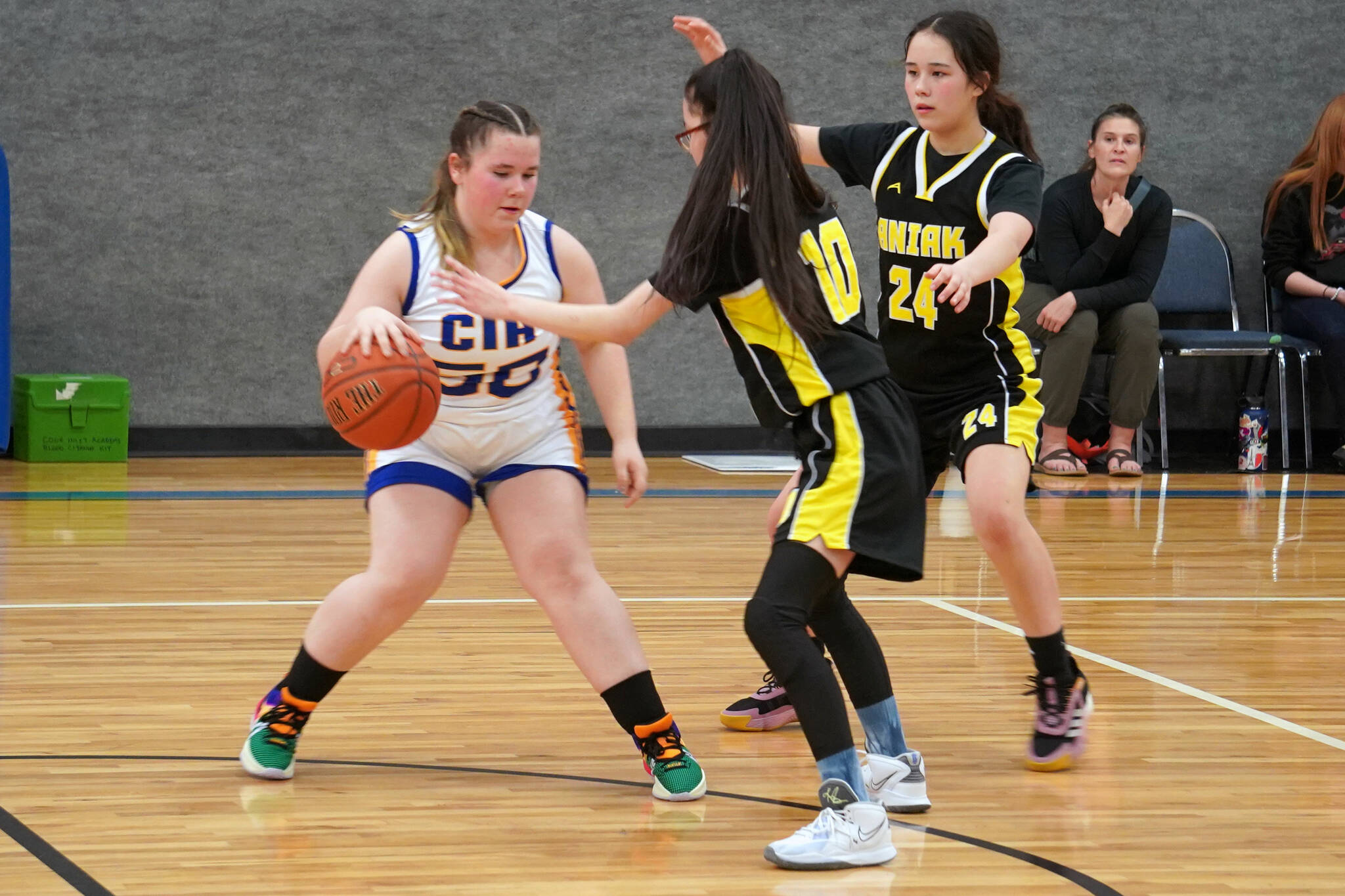 Cook Inlet Academy’s Maria Smith battles to maintain control of the ball against defense by Aniak’s Leona Morgan and Maddison Steeves during a basketball game at Cook Inlet Academy in Soldotna, Alaska, on Tuesday, Feb. 13, 2024. (Jake Dye/Peninsula Clarion)
