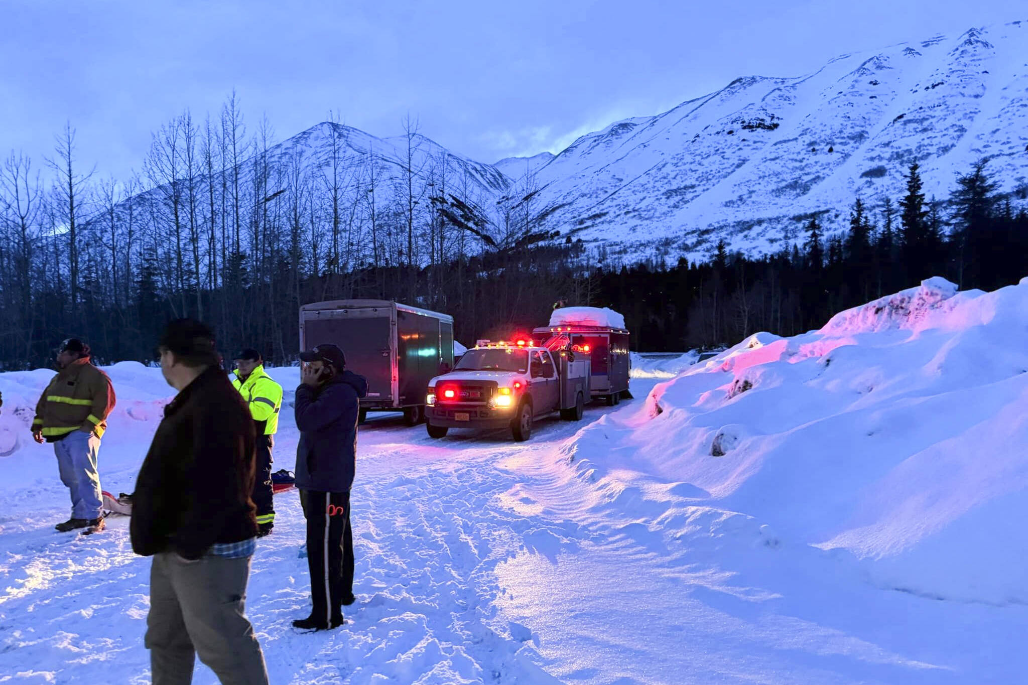 In this image provided by the Cooper Landing Emergency Services, emergency personnel respond to reports of an avalanche on Tuesday, Feb. 13, 2024, in Cooper Landing, Alaska. One backcountry skier died and two others were injured in an avalanche on Alaska’s Kenai Peninsula, as warm weather raises the risk for such events in the state. (Clay Adam/Cooper Landing Emergency Services via AP)