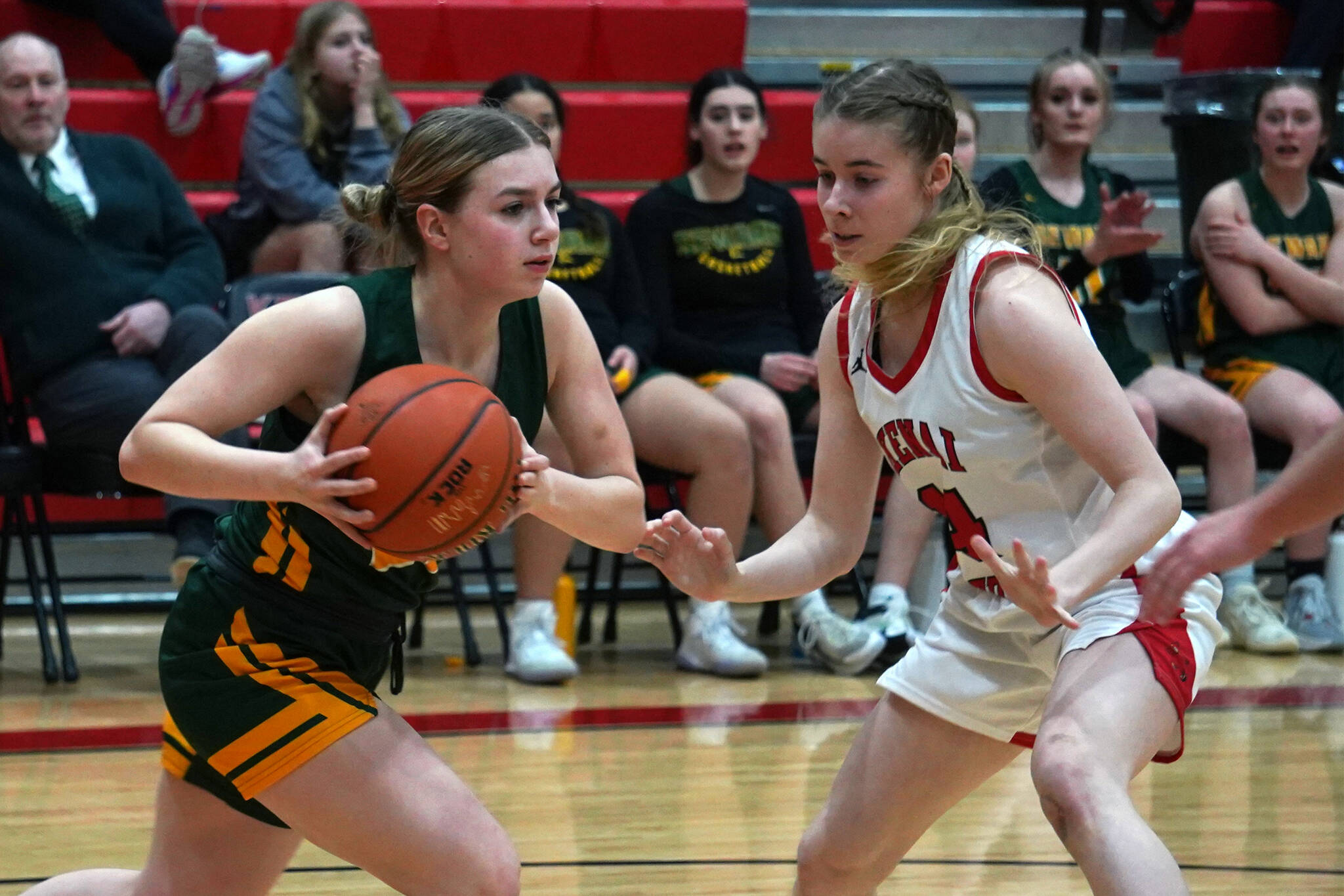 Seward’s Ava Jagielski moves with ball as Kenai’s Avia Miller blocks during a basketball game at Kenai Central High School in Kenai, Alaska, on Friday, Feb. 16, 2024. (Jake Dye/Peninsula Clarion)