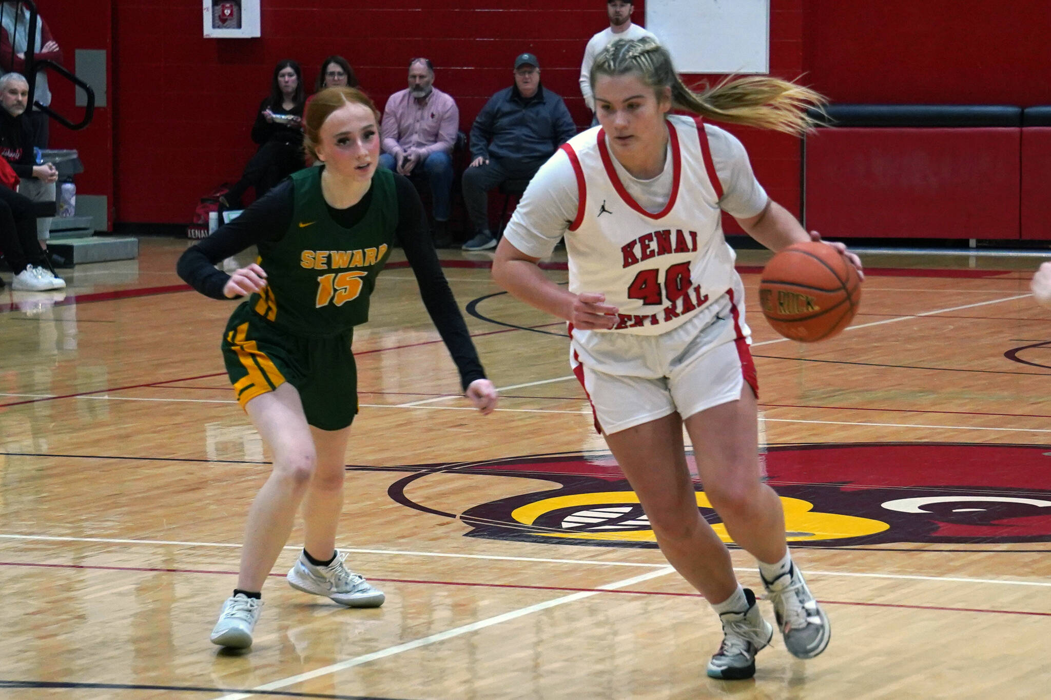 Kenai’s Emma Beck moves with ball as Seward’s Natalie Sieminski pursues during a basketball game at Kenai Central High School in Kenai, Alaska, on Friday, Feb. 16, 2024. (Jake Dye/Peninsula Clarion)