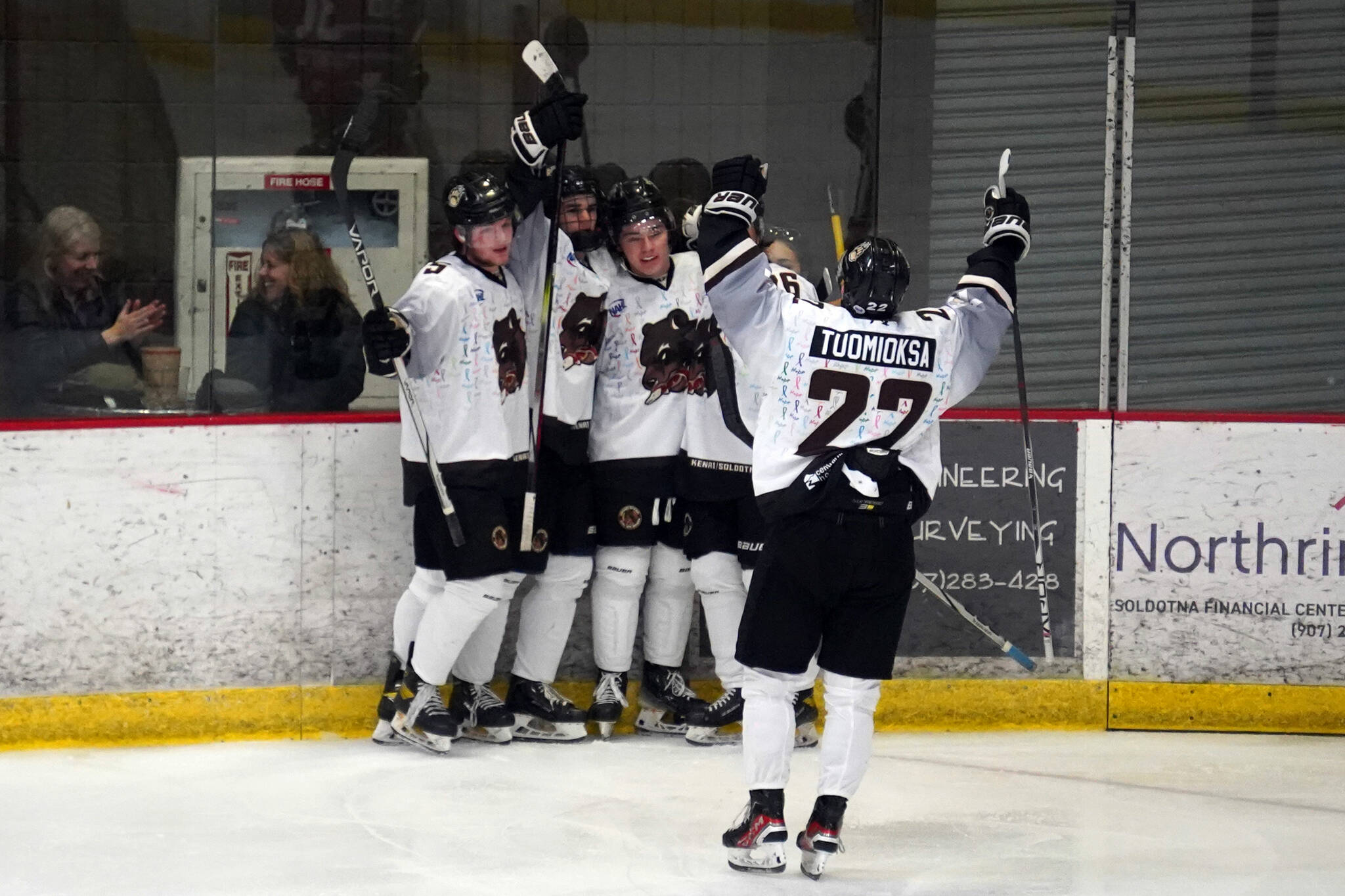 The Kenai River Brown Bears celebrate a goal by Dylan Contreras, center, during a hockey game at the Soldotna Regional Sports Complex in Soldotna, Alaska, on Friday, Feb. 23, 2024. (Jake Dye/Peninsula Clarion)