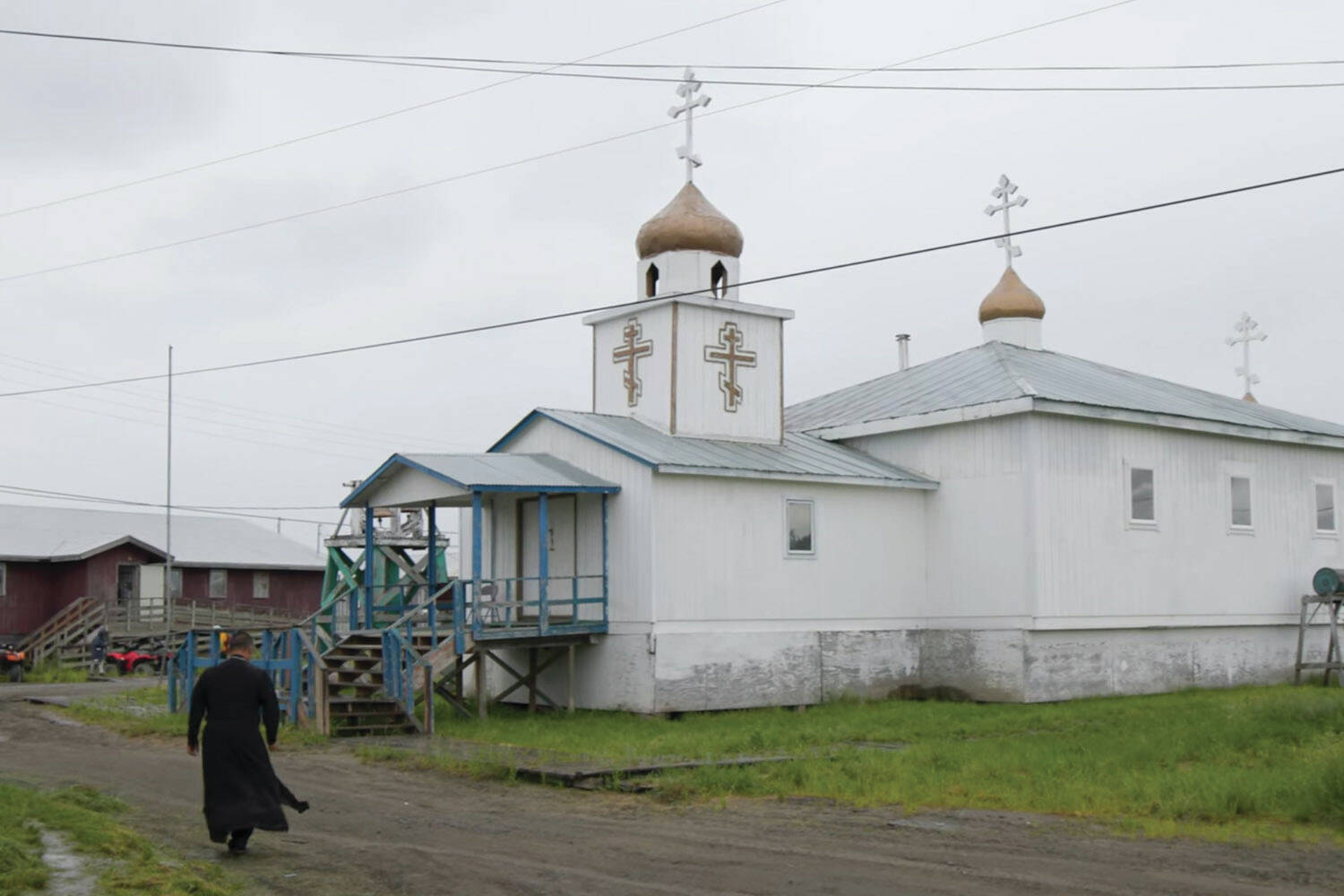 An Alaska Native man walks towards an Orthodox church in a screenshot from “Sacred Alaska.” (Promotional image courtesy Simon Scionka)