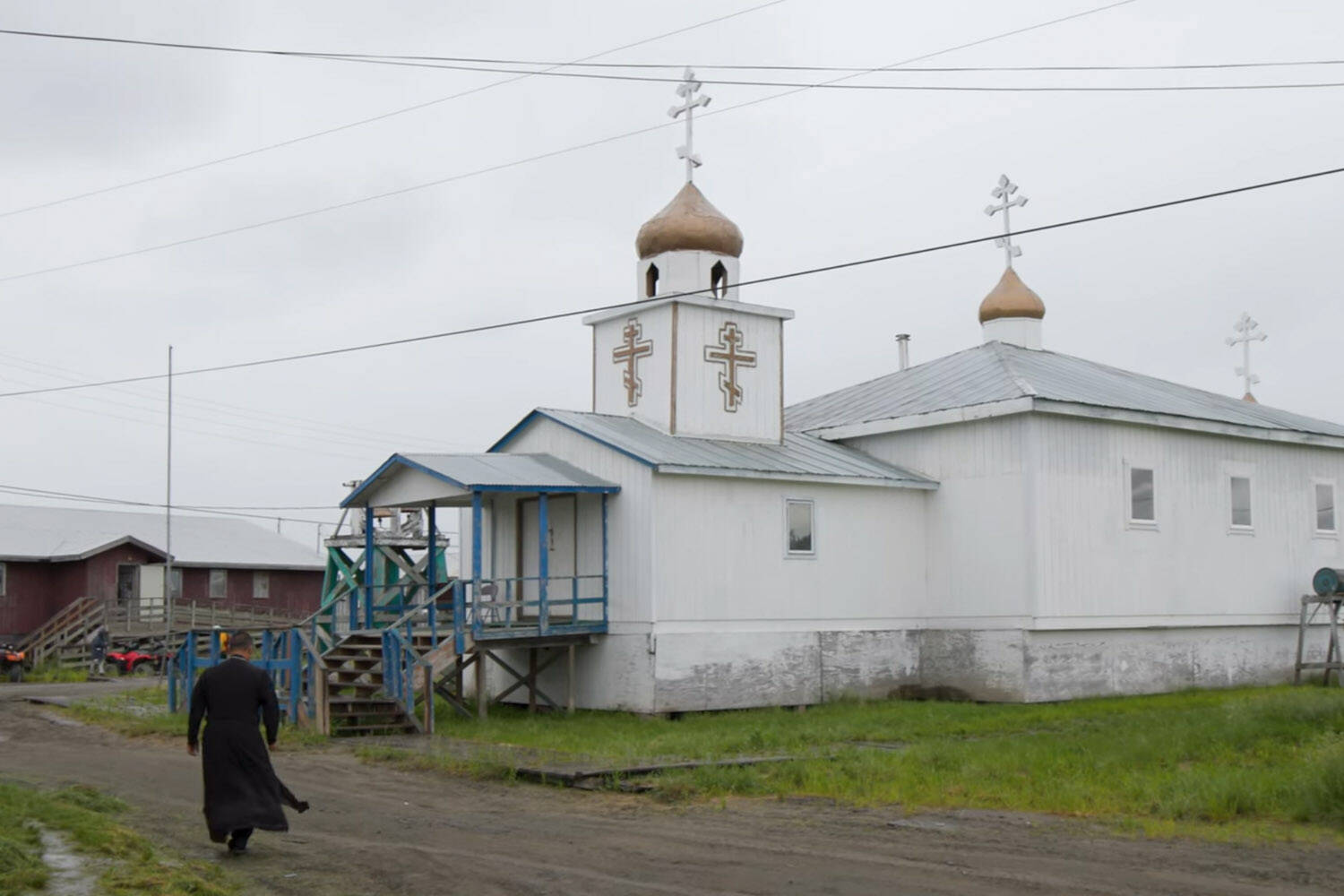 An Alaska Native man walks towards an Orthodox church in a screenshot from Sacred Alaska. (Promotional image courtesy Simon Scionka)