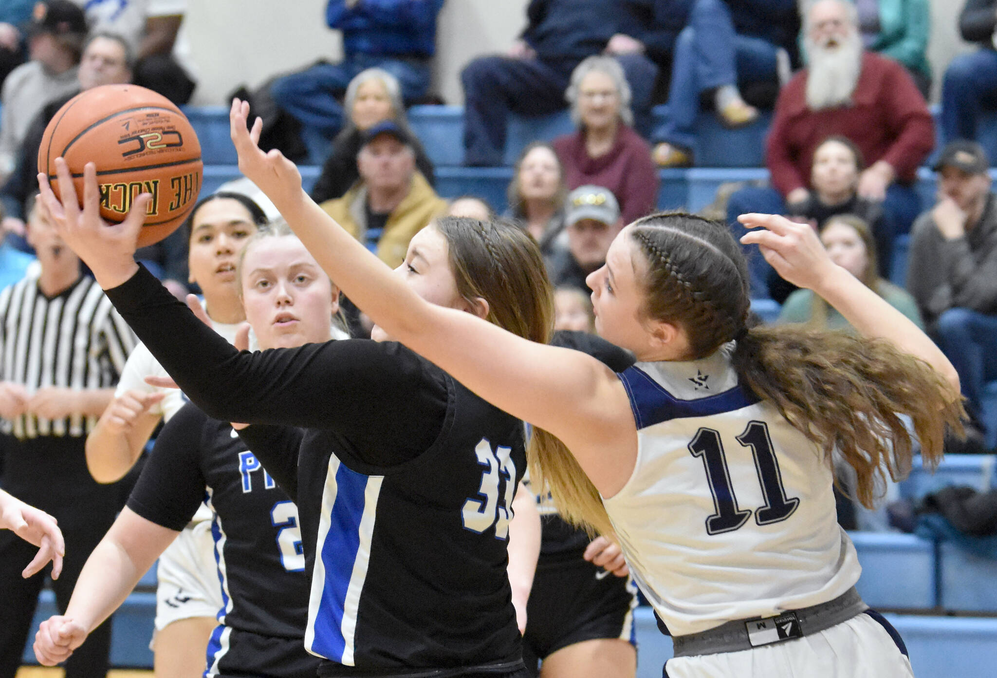Palmer’s Kaelyn Downey and Soldotna’s Juliet Innes battle for the ball Thursday, March 7, 2024, at the Northern Lights Conference tournament at Soldotna High School in Soldotna, Alaska. (Photo by Jeff Helminiak/Peninsula Clarion)