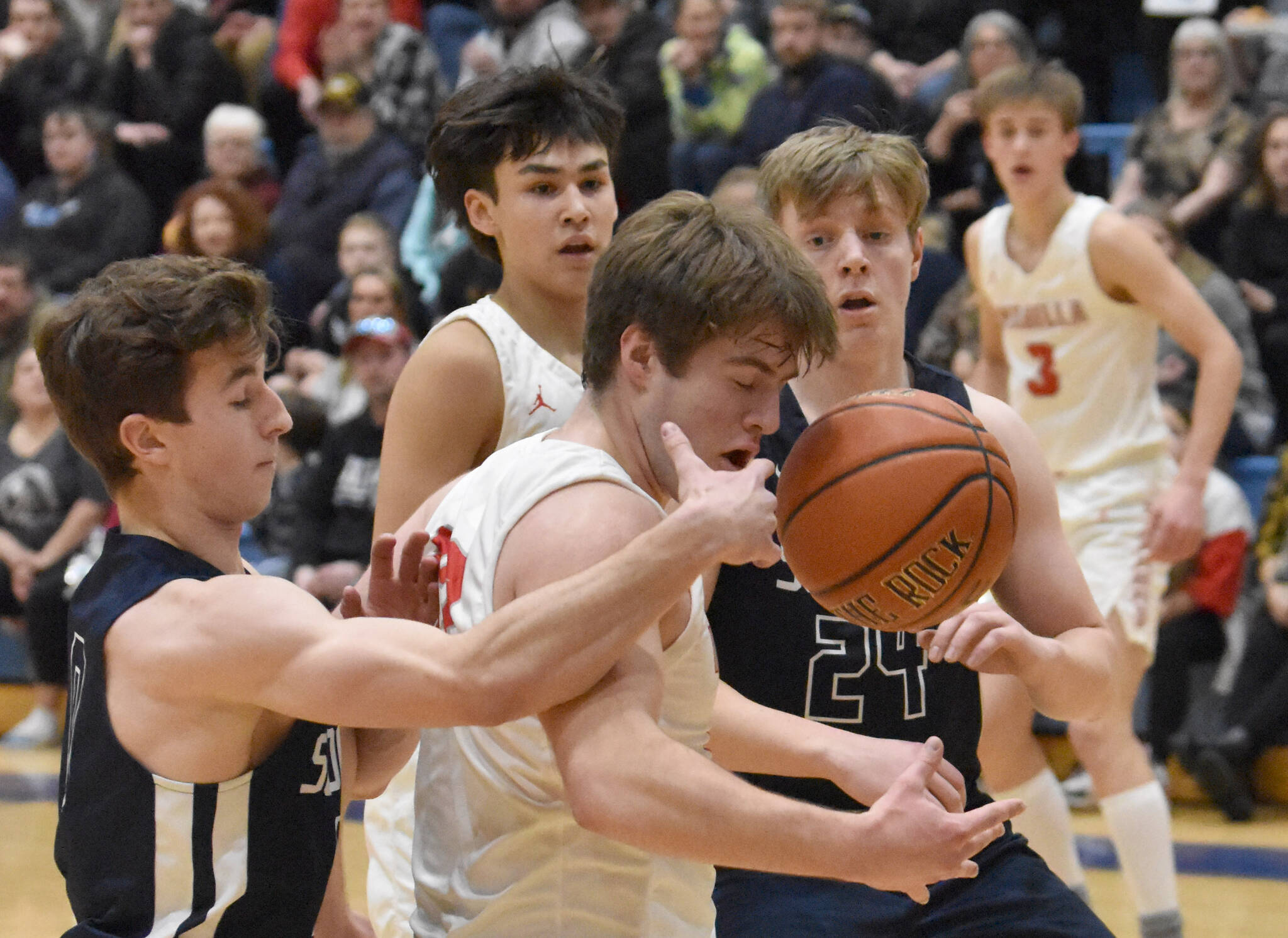 Soldotna’s Zac Buckbee and Wasilla’s Eli Cox battle for the ball Friday, March 8, 2024, at the Northern Lights Conference tournament at Soldotna High School in Soldotna, Alaska. (Photo by Jeff Helminiak/Peninsula Clarion)