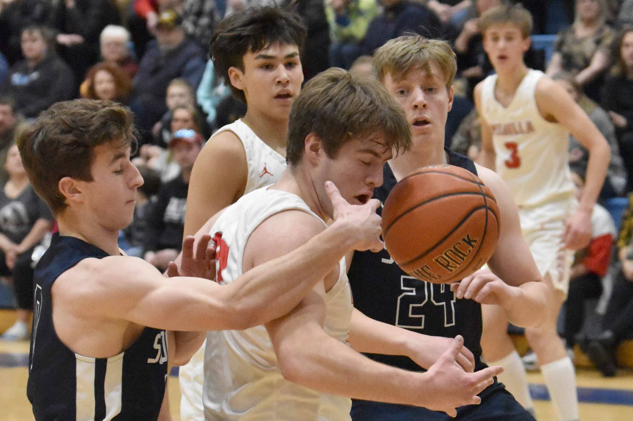 Soldotna's Zac Buckbee and Wasilla's Eli Cox battle for the ball Friday, March 8, 2024, at the Northern Lights Conference tournament at Soldotna High School in Soldotna, Alaska. (Photo by Jeff Helminiak/Peninsula Clarion)