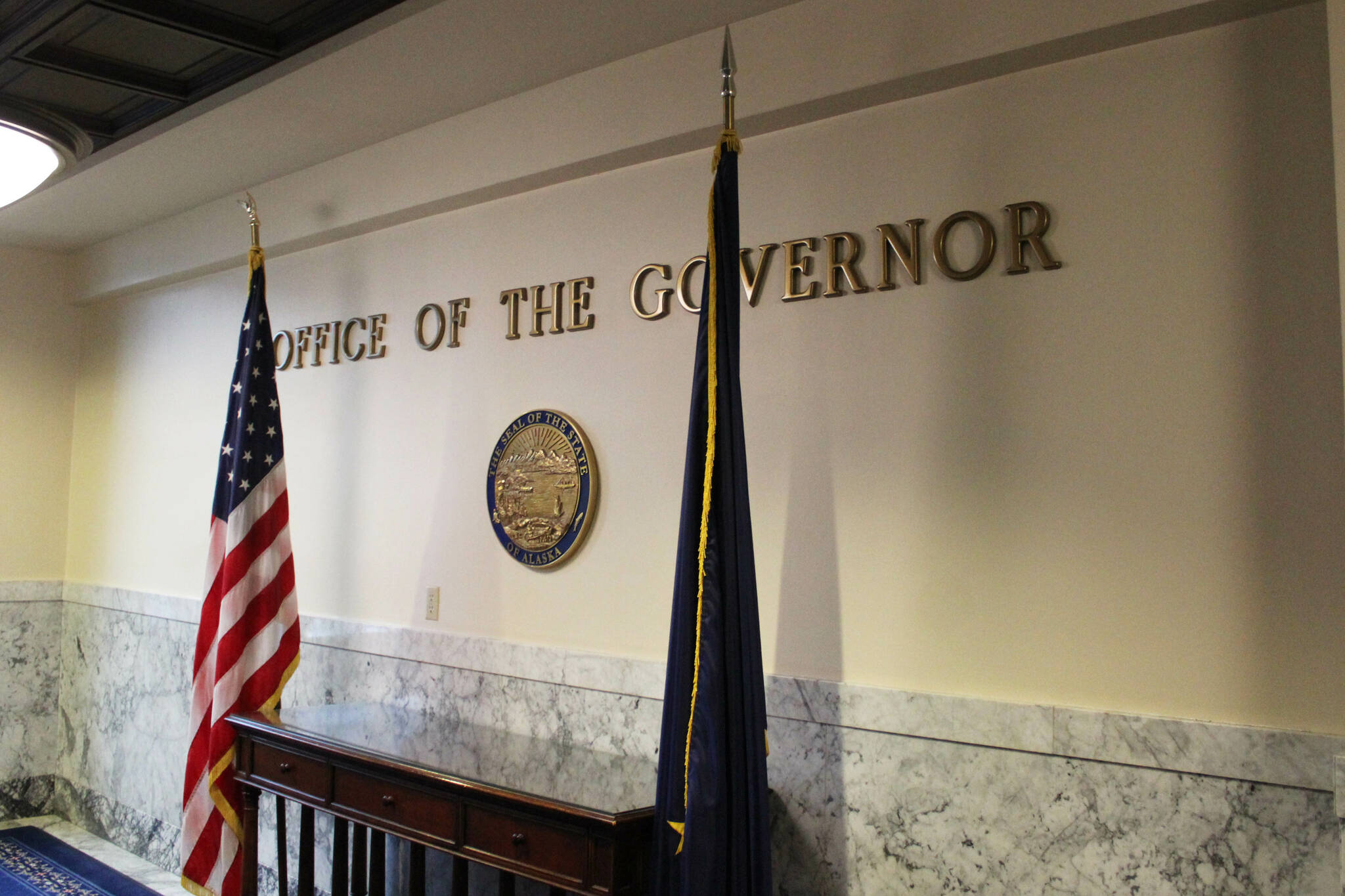 Flags flank the entrance to Gov. Mike Dunleavy’s office on Thursday, March 14, 2024, in Juneau, Alaska. (Ashlyn O’Hara/Peninsula Clarion)