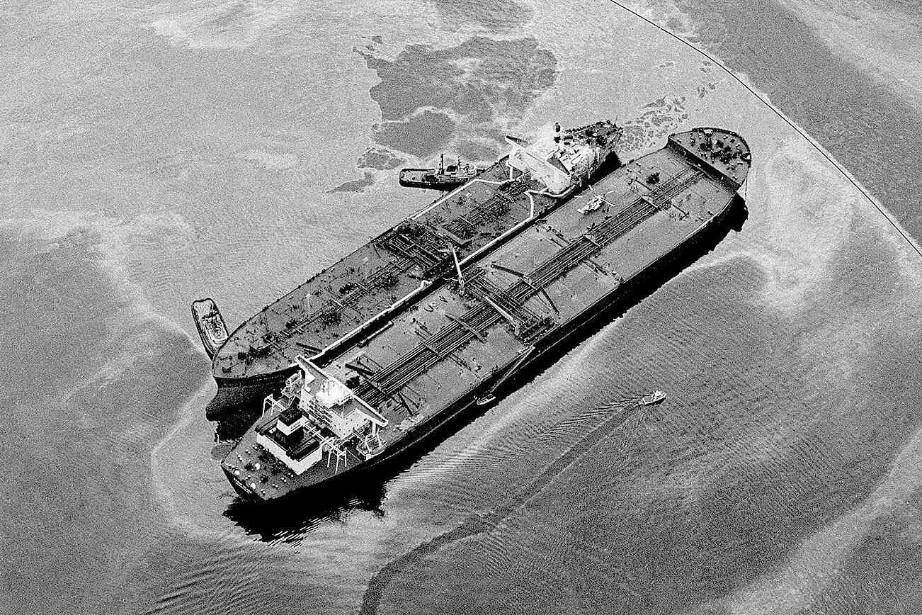 The Exxon Baton Rouge, smaller ship, attempts to off-load crude from the Exxon Valdez that ran aground in Prince William Sound, Valdez, Alaska, spilling over 270,000 barrels of crude oil, shown March 26, 1989. (AP Photo/Rob Stapleton)