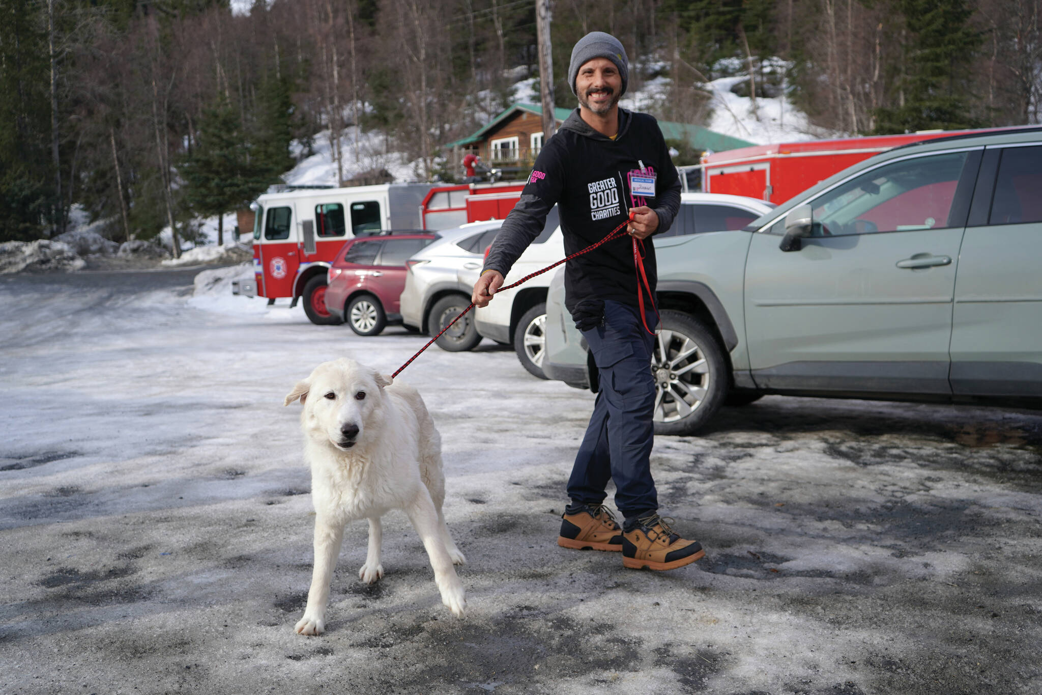 Jake Dye/Peninsula Clarion
A veterinarian with Greater Good Charities escorts dog Maggie into a free spay/neuter clinic at the Moose Pass Fire Station on Thursday.