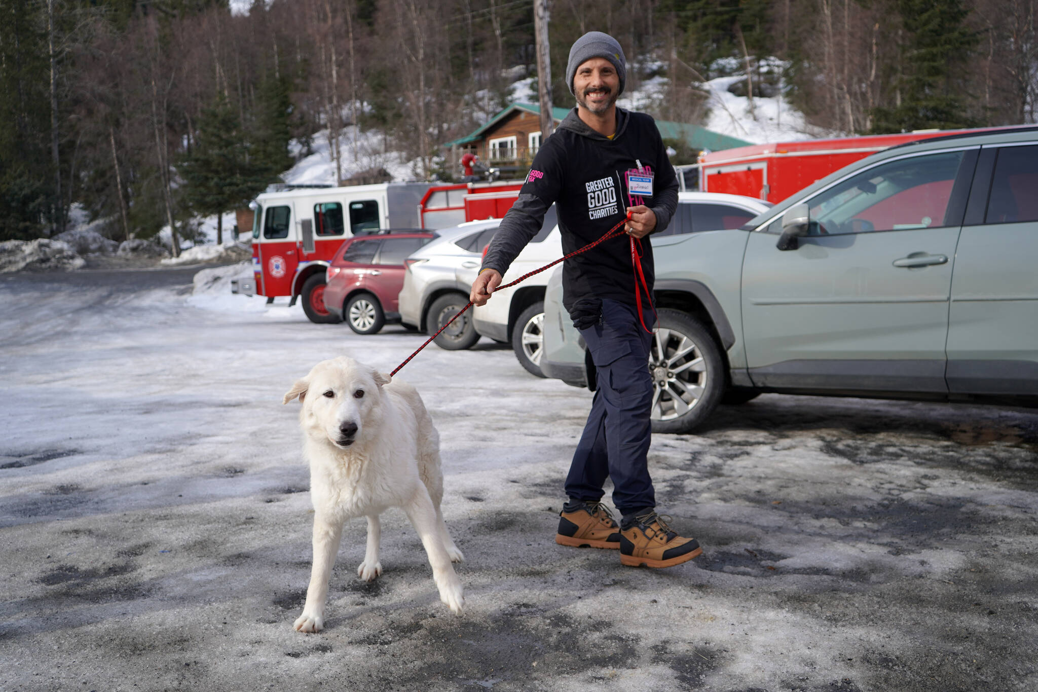 Maggie is escorted into a free spay/neuter clinic at the Moose Pass Fire Station in Moose Pass, Alaska, on Thursday, March 21, 2024. (Jake Dye/Peninsula Clarion)