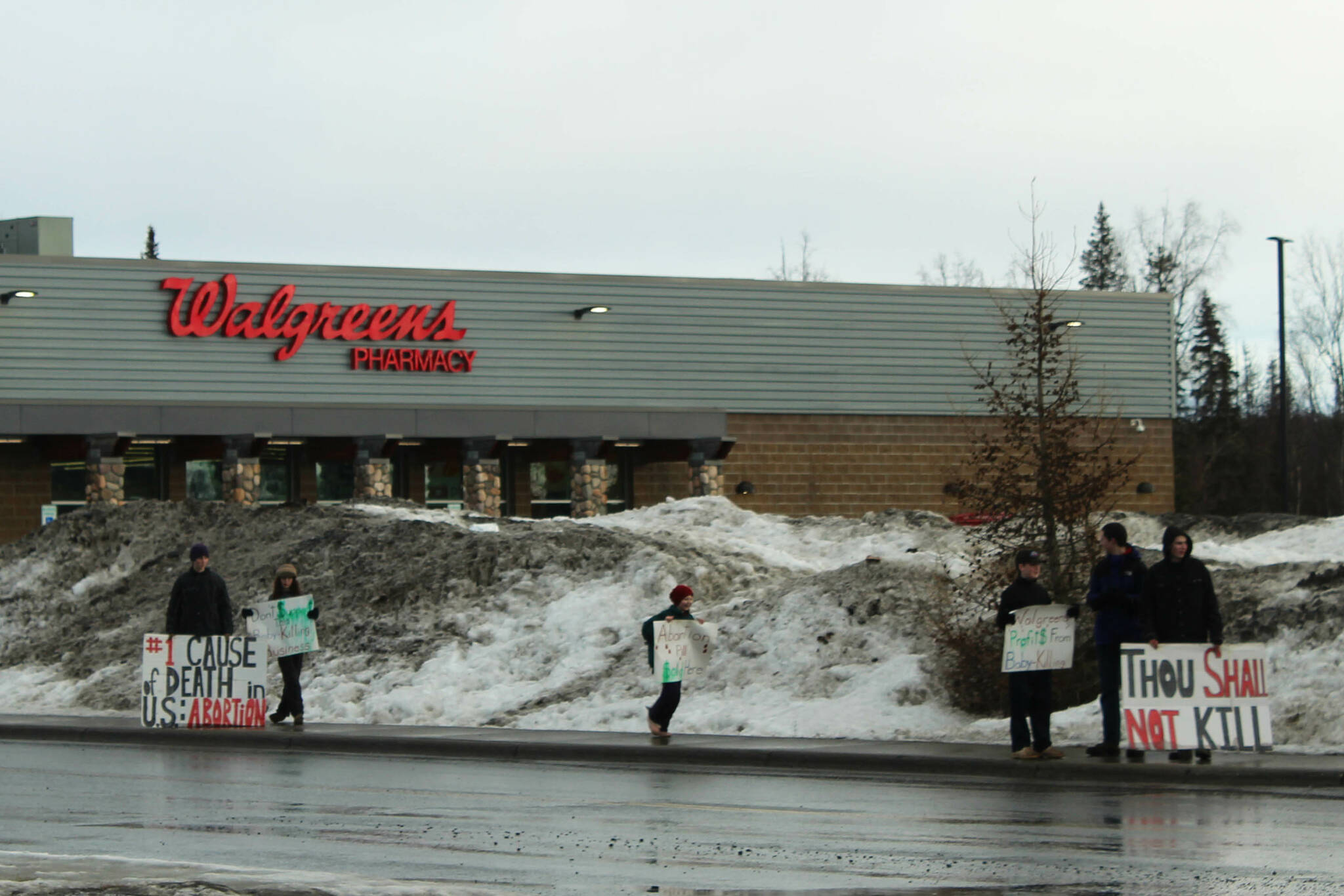 Anti-abortion demonstrators protest outside Walgreens in Soldotna on Tuesday, March 27, 2024, in Soldotna, Alaska. The protesters say the company is distributing mifepristone, which is one half of a medicine series used to end a pregnancy through 10 weeks of gestation. The company denies distributing the drug at Alaska locations. (Ashlyn O’Hara/Peninsula Clarion)