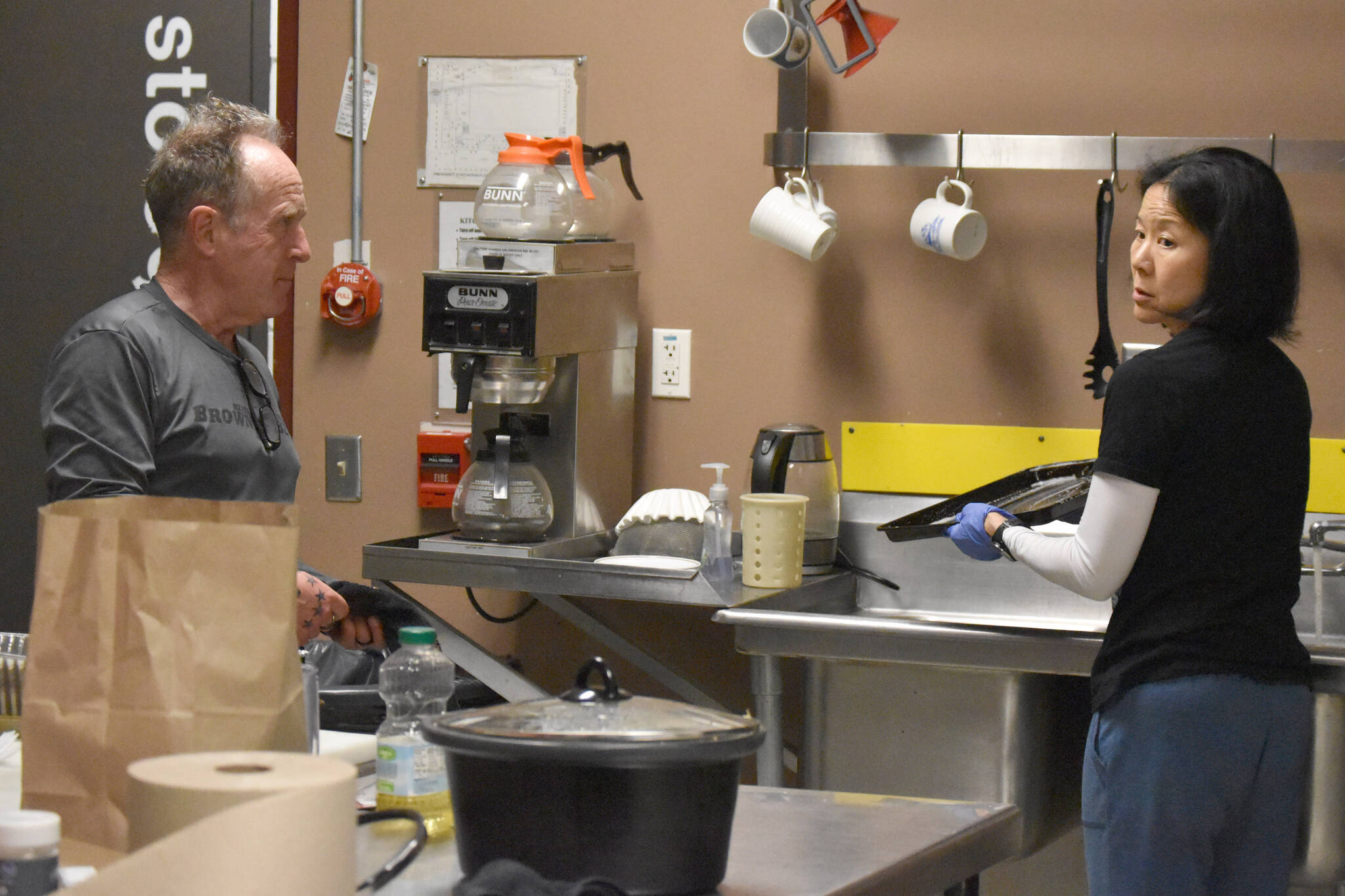 John Bryan and Candace Nakagawa, Co-Directors of Sports Science, Strength and Conditioning, clean up the kitchen after preparing a meal for the Kenai River Brown Bears at the Soldotna Regional Sports Complex in Soldotna, Alaska, on Friday, March 29, 2024. (Photo by Jeff Helminiak/Peninsula Clarion)