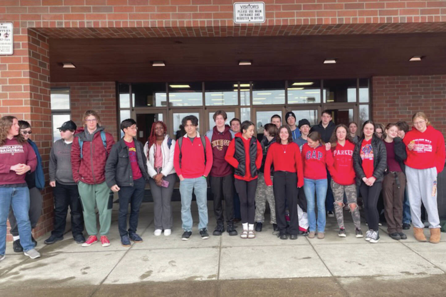 Homer High School students who joined schools from around the state in a high school walkout pose near the end of the event, on Thursday, April 4, 2024, in Homer, Alaska. Not all students who attended the event are in the image. (Photo by Emilie Springer/Homer News)