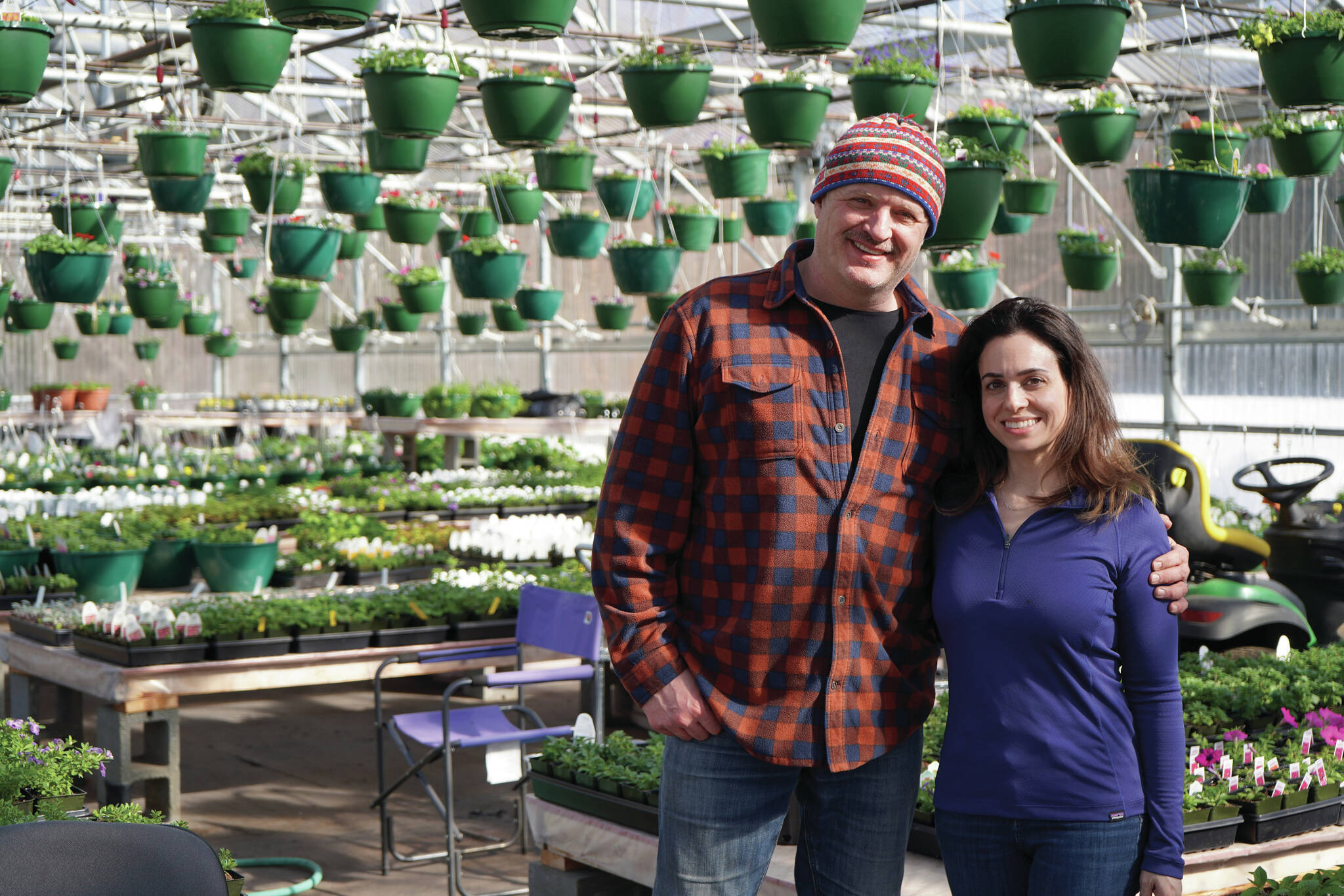 Jake Dye/Peninsula Clarion
John and Parrisa Harris are surrounded by plants and flowers in the newly reopened Fireweed Greenhouse in Kenai on Sunday.