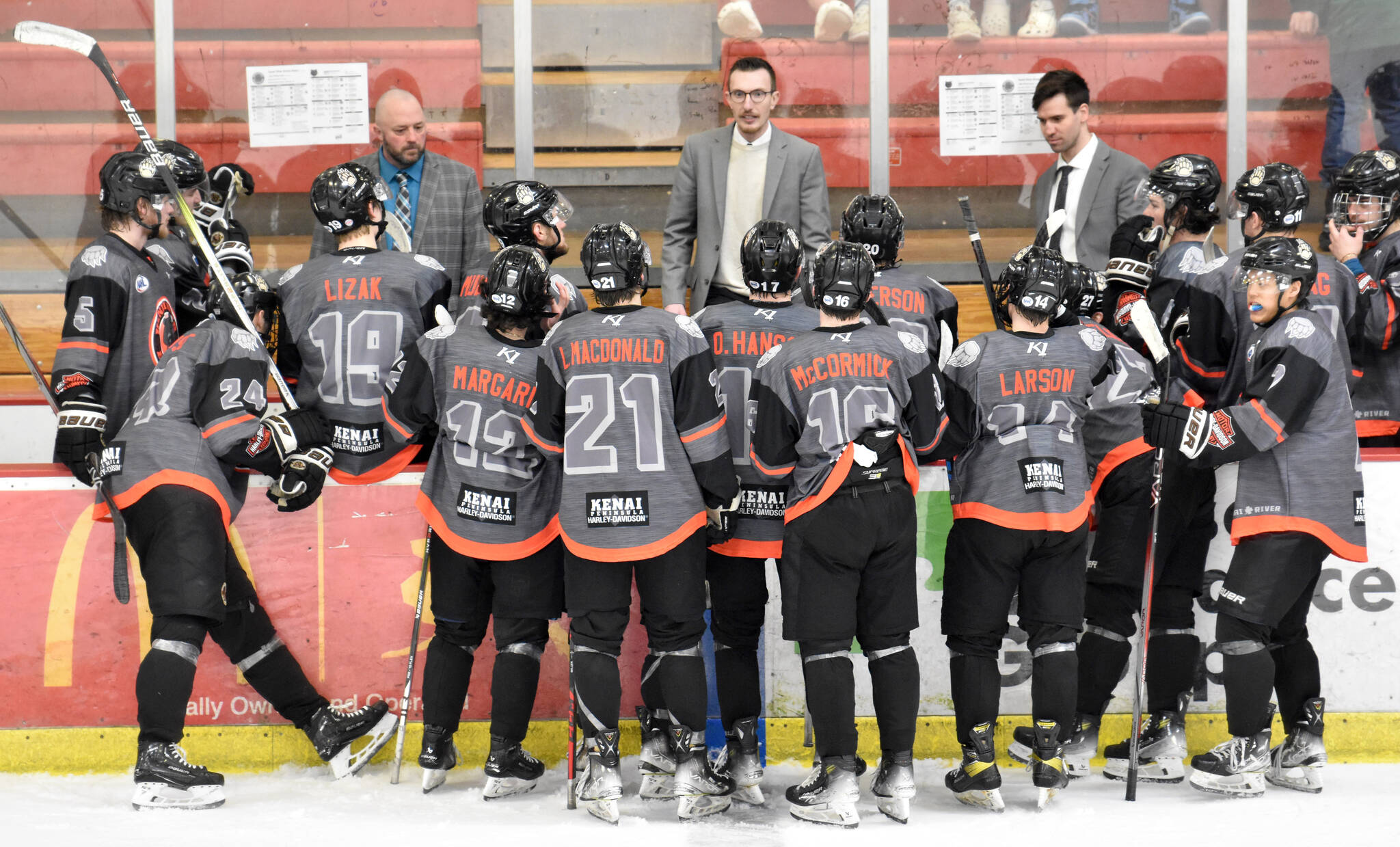 Head coach Taylor Shaw (center) talks to the Kenai River Brown Bears during a timeout at the Soldotna Regional Sports Complex in Soldotna, Alaska, on Saturday, March 23, 2024. (Photo by Jeff Helminiak/Peninsula Clarion)