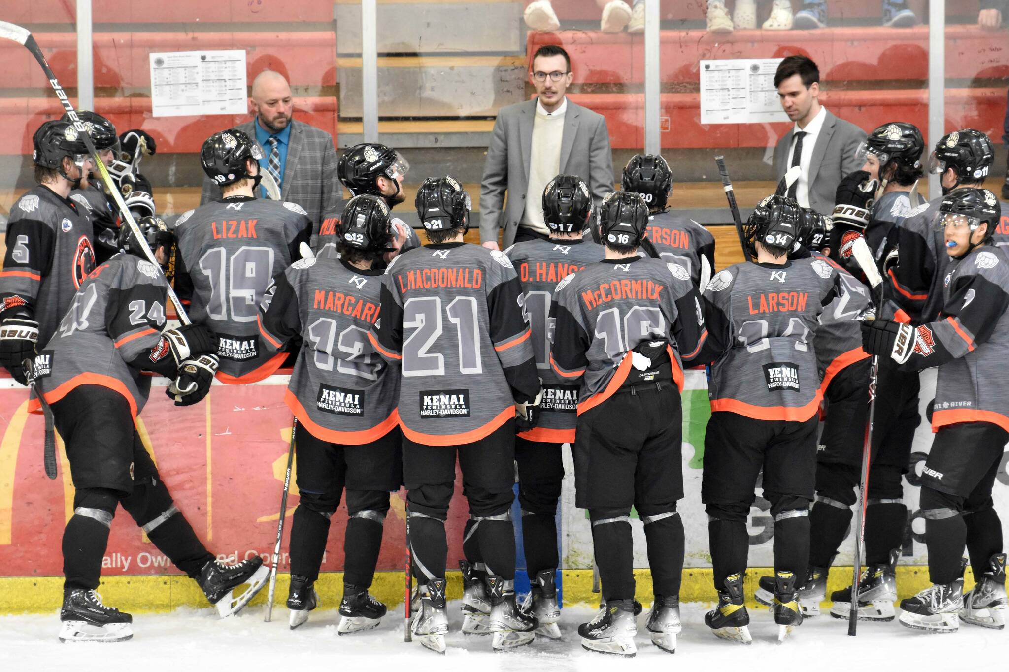 Head coach Taylor Shaw (center) talks to the Kenai River Brown Bears during a timeout at the Soldotna Regional Sports Complex in Soldotna, Alaska, on Saturday, March 23, 2024. (Photo by Jeff Helminiak/Peninsula Clarion)