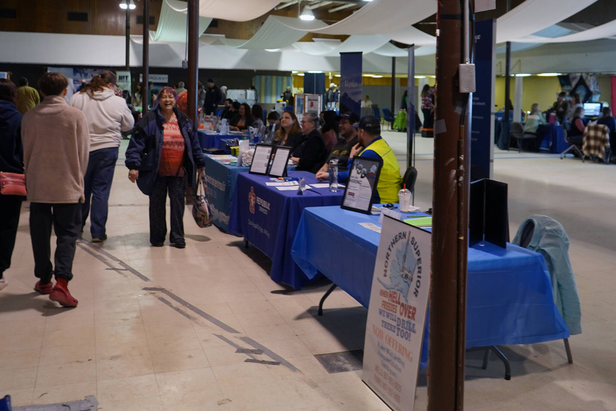 Attendees mill between vendor tables during the Kenai Peninsula Job and Career Fair in Kenai, Alaska, on Wednesday, April 10, 2024. (Jake Dye/Peninsula Clarion)