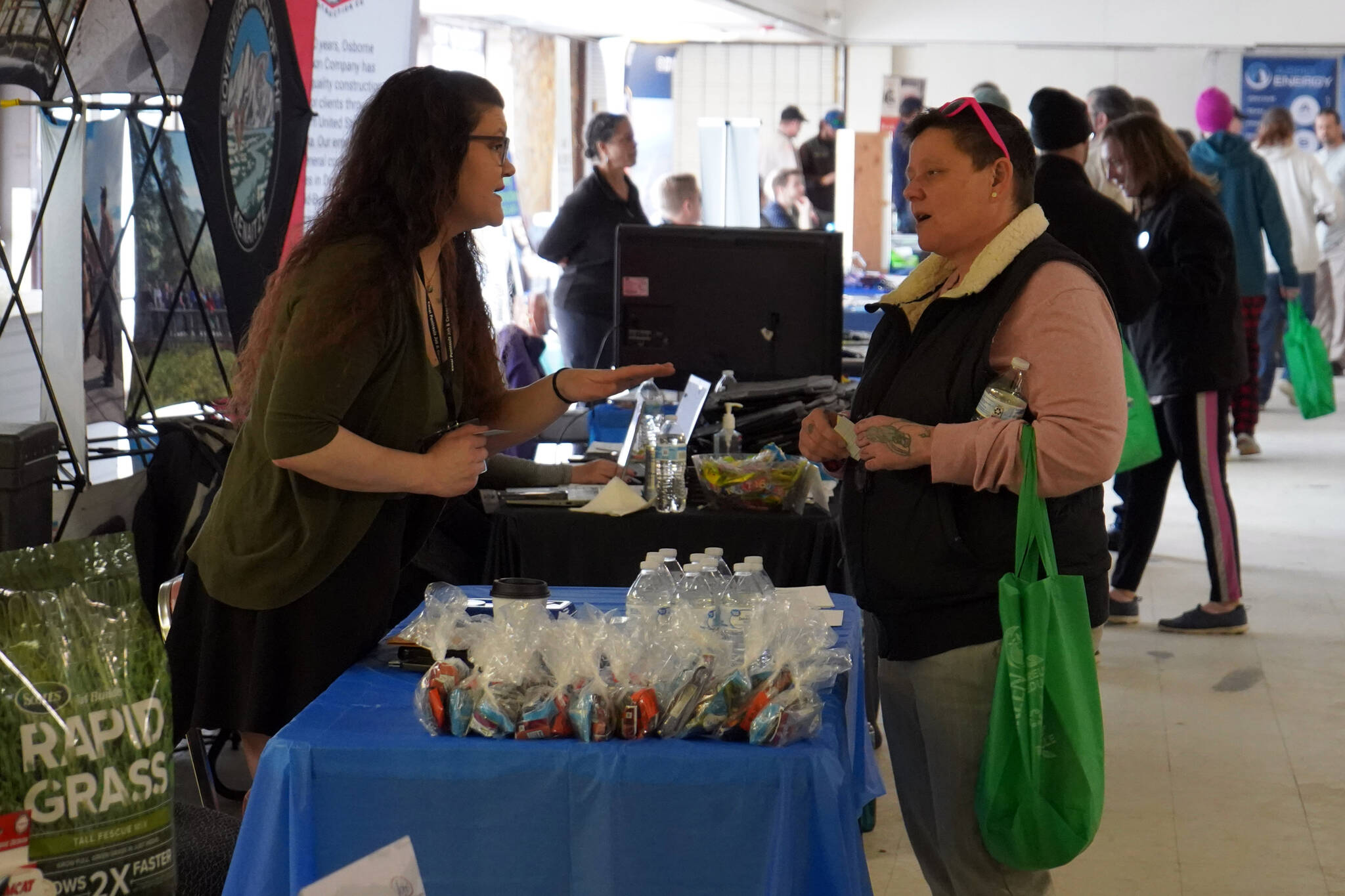 Vendors speak to attendees of the Kenai Peninsula Job and Career Fair in Kenai, Alaska, on Wednesday, April 10, 2024. (Jake Dye/Peninsula Clarion)