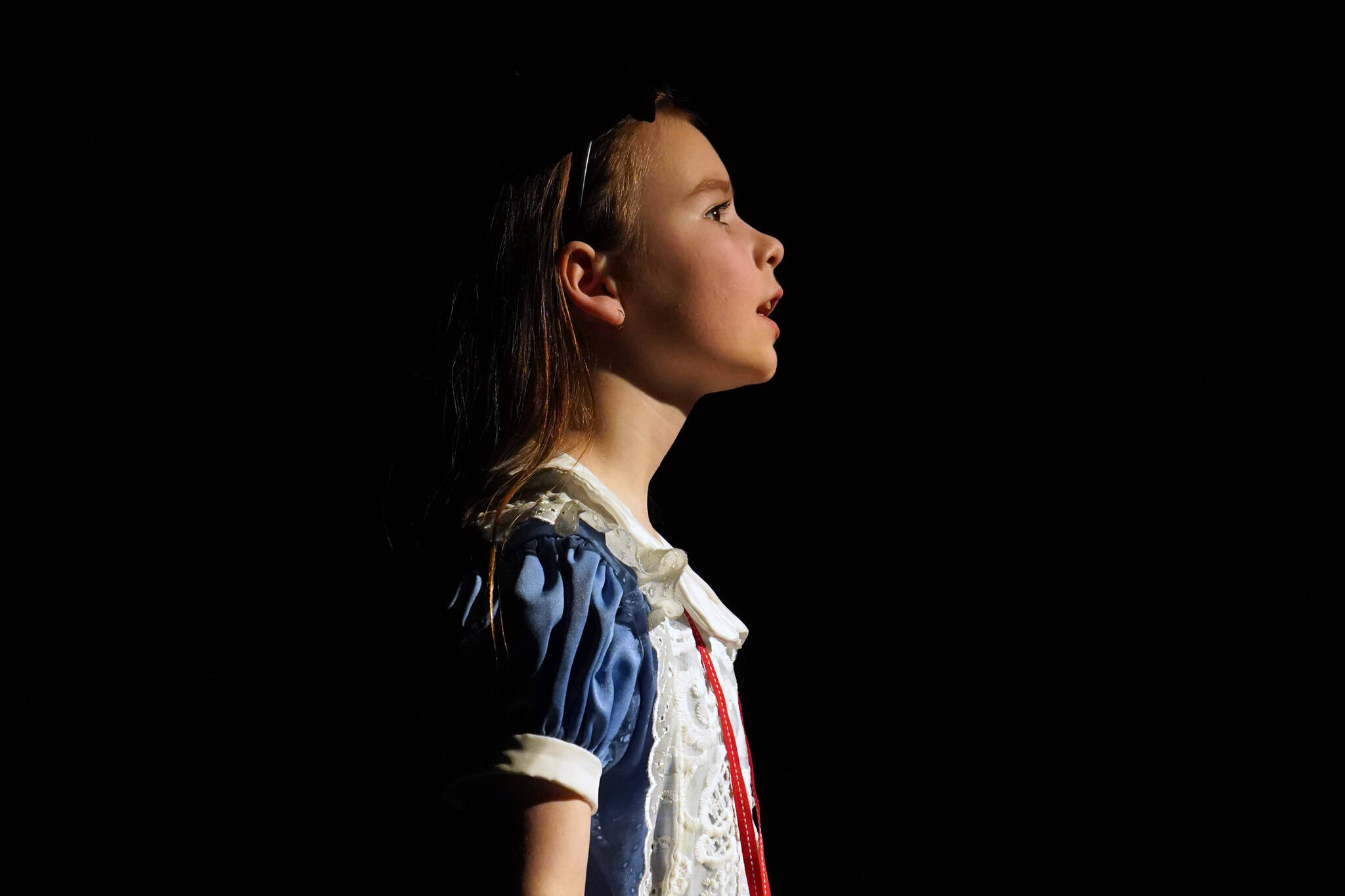 Aurora Bukac is Alice in a rehearsal of Seward High School Theatre Collective’s production of “Alice in Wonderland” at Seward High School in Seward, Alaska, on Thursday, April 11, 2024. (Jake Dye/Peninsula Clarion)