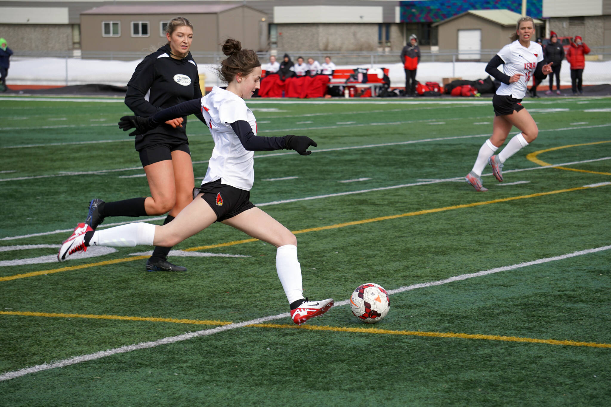 Sarah Baisden winds to kick during a soccer game at Ed Hollier Field in Kenai, Alaska, on Friday, April 12, 2024. (Jake Dye/Peninsula Clarion)