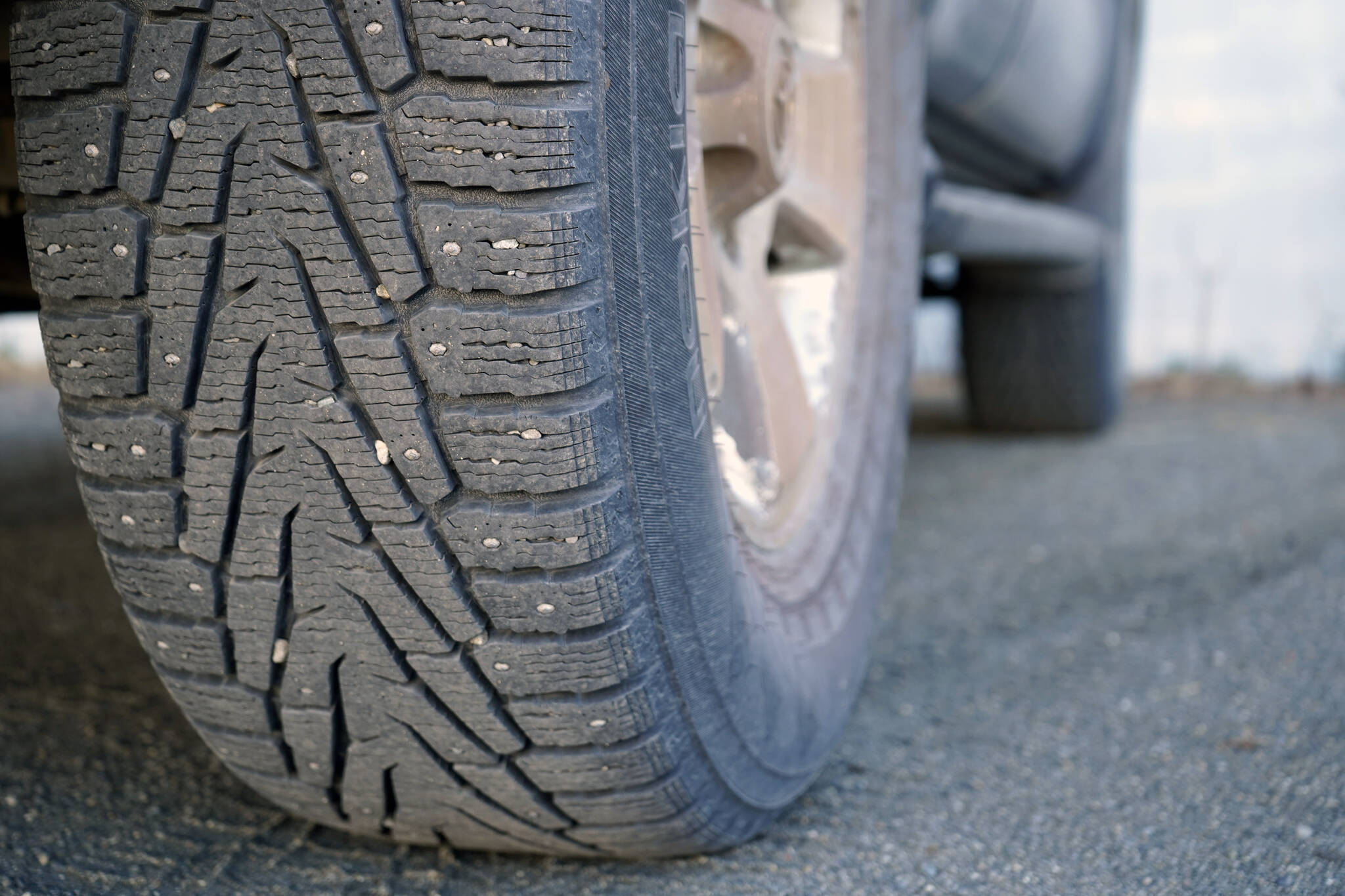 A studded tire is attached to a very cool car in the parking lot of the Peninsula Clarion in Kenai, Alaska, on Monday, April 15, 2024. (Jake Dye/Peninsula Clarion)