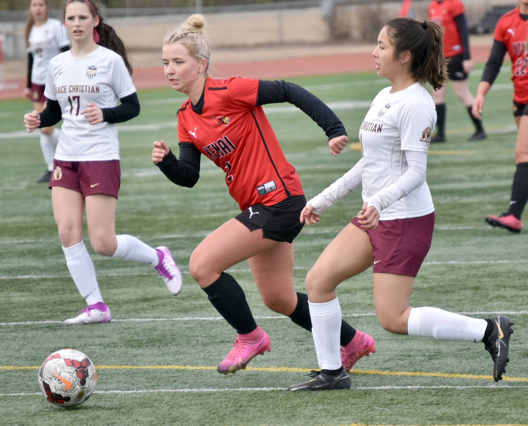 Kenai Central’s Brynnen Hanson dribbles against Grace Christian’s Josie Evans-Grant on Friday, April 19, 2024, at Kenai Central High School in Kenai, Alaska. (Photo by Jeff Helminiak/Peninsula Clarion)