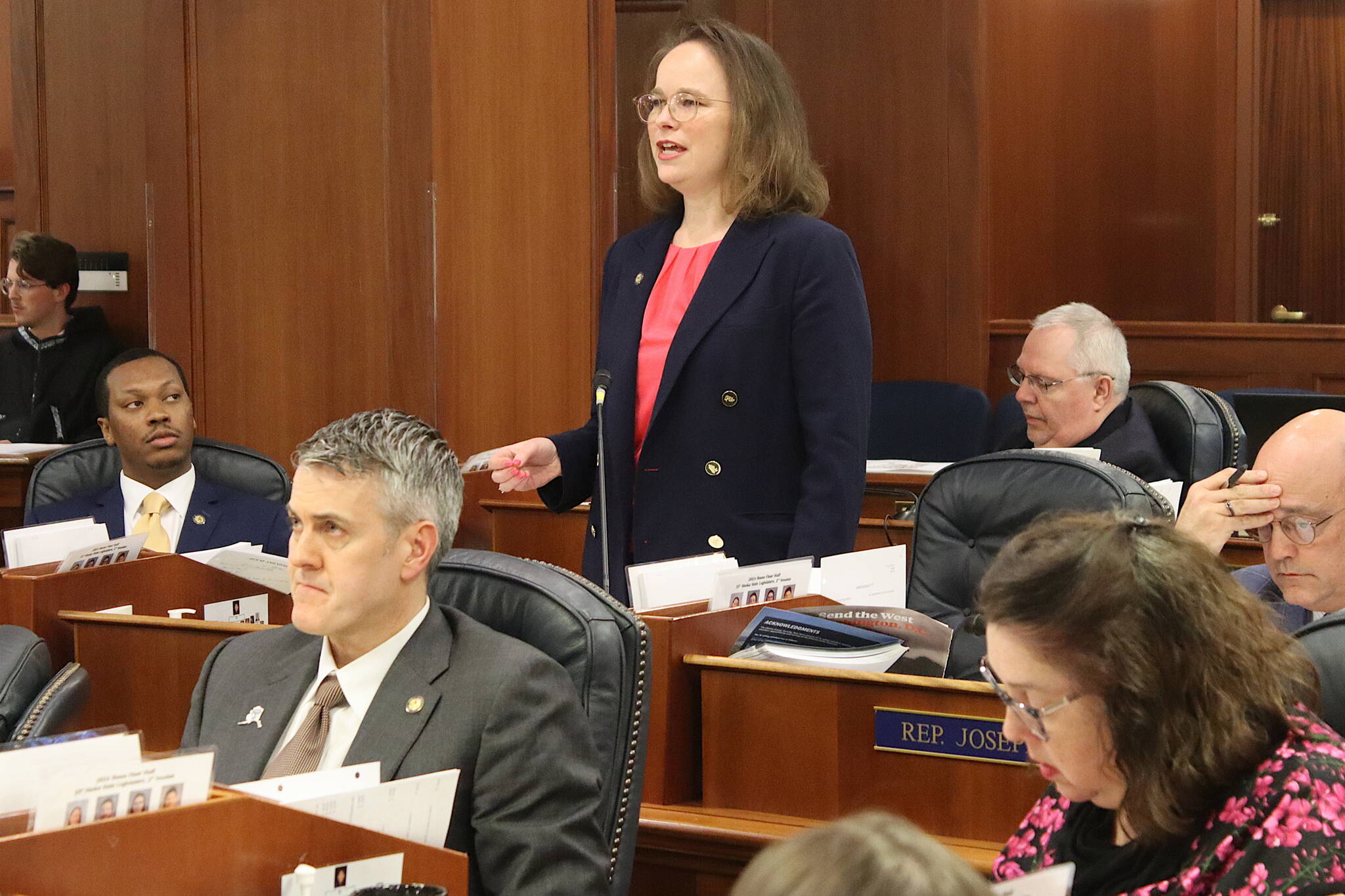 Rep. Sarah Vance, a Homer Republican, discusses a bill she sponsored requiring age verification to visit pornography websites while Rep. Andrew Gray, an Anchorage Democrat who added an amendment prohibiting children under 14 from having social media accounts, listens during a House floor session Friday. (Mark Sabbatini / Juneau Empire)