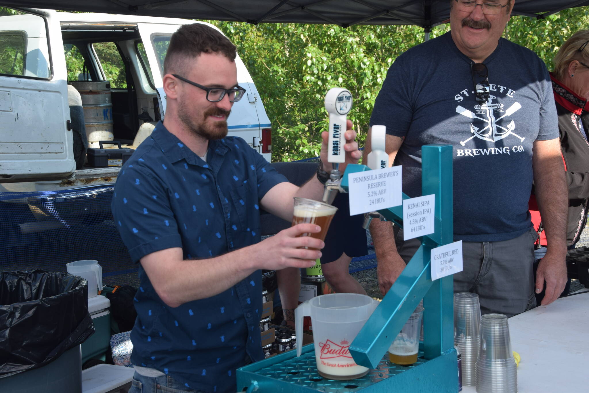 Ben Weagraff from Kenai River Brewing Company works the beer garden at Soldotna Creek Park during the Levitt AMP Soldotna Music Series on Wednesday, June 12, 2019. (Photo by Brian Mazurek/Peninsula Clarion)