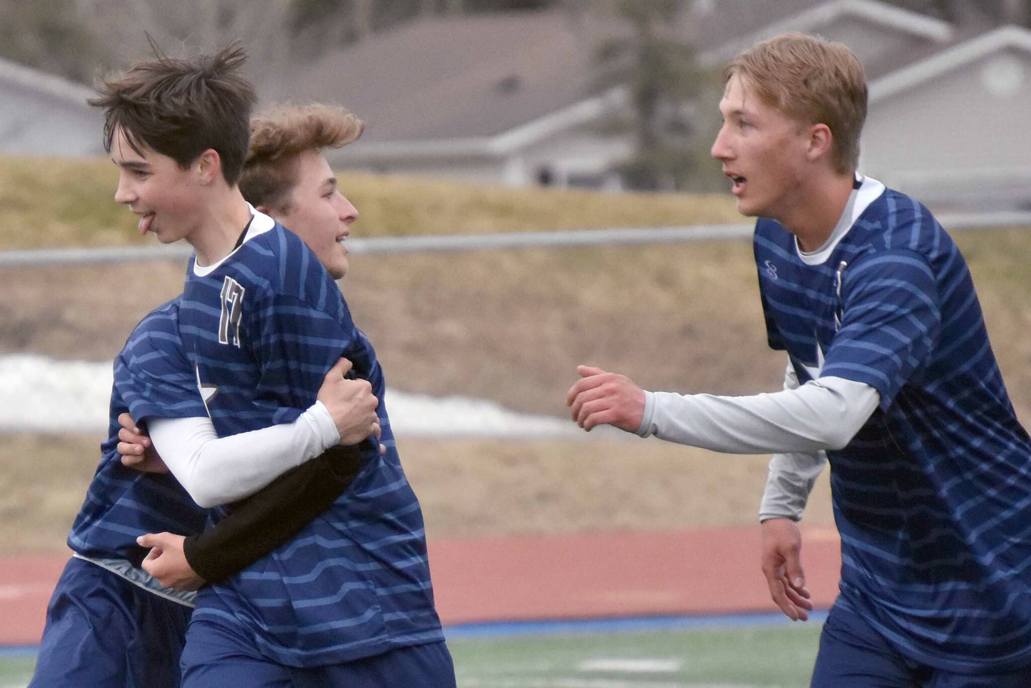 Soldotna's Lane Hillyer (front) celebrates his goal against Ketchikan with teammates Thursday, May 2, 2024, at Soldotna High School in Soldotna, Alaska. (Photo by Jeff Helminiak/Peninsula Clarion)