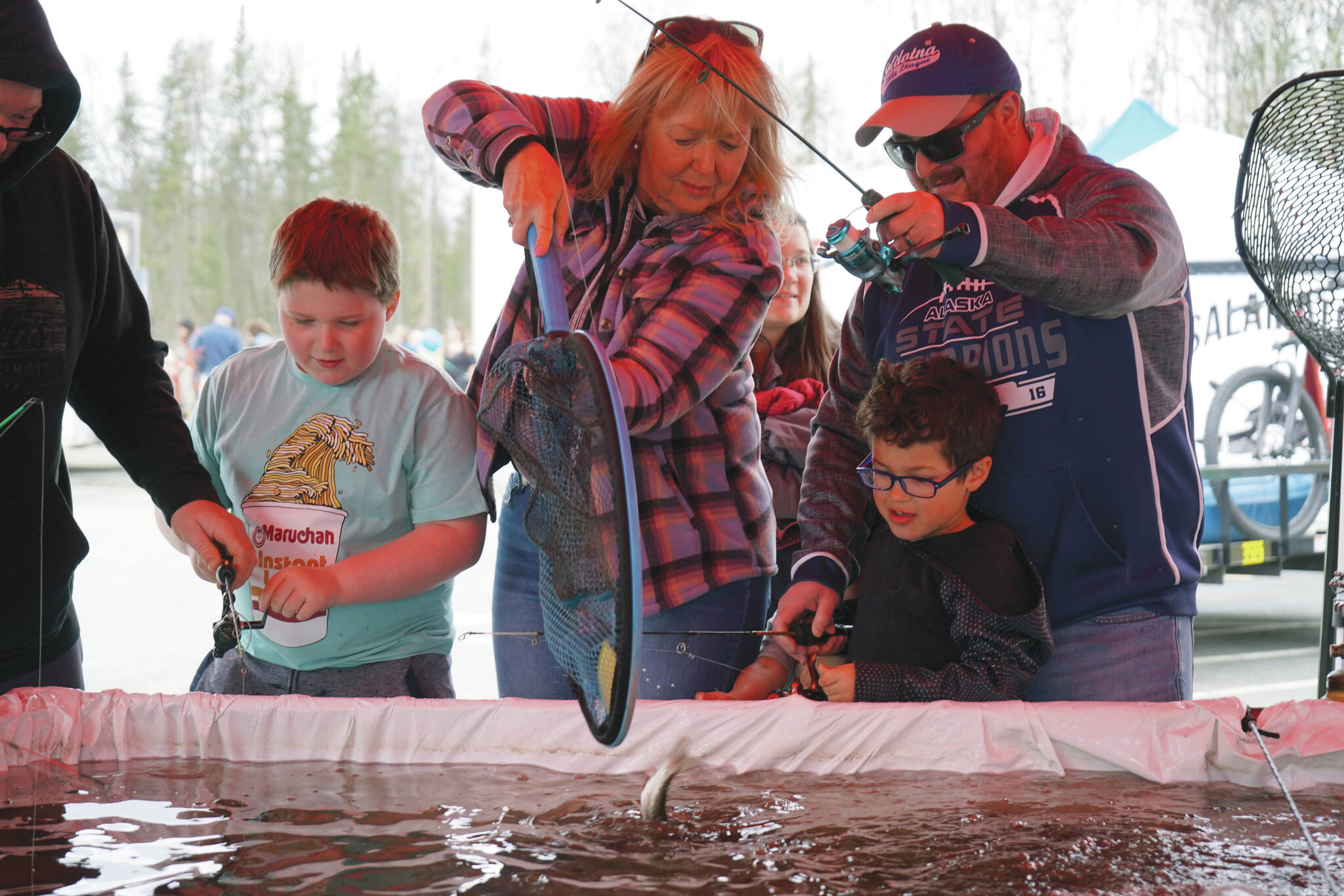 Jake Dye/Peninsula Clarion
A rainbow trout is lifted into a net during the Sport, Rec and Trade Show at the Soldotna Regional Sports Complex on Saturday.