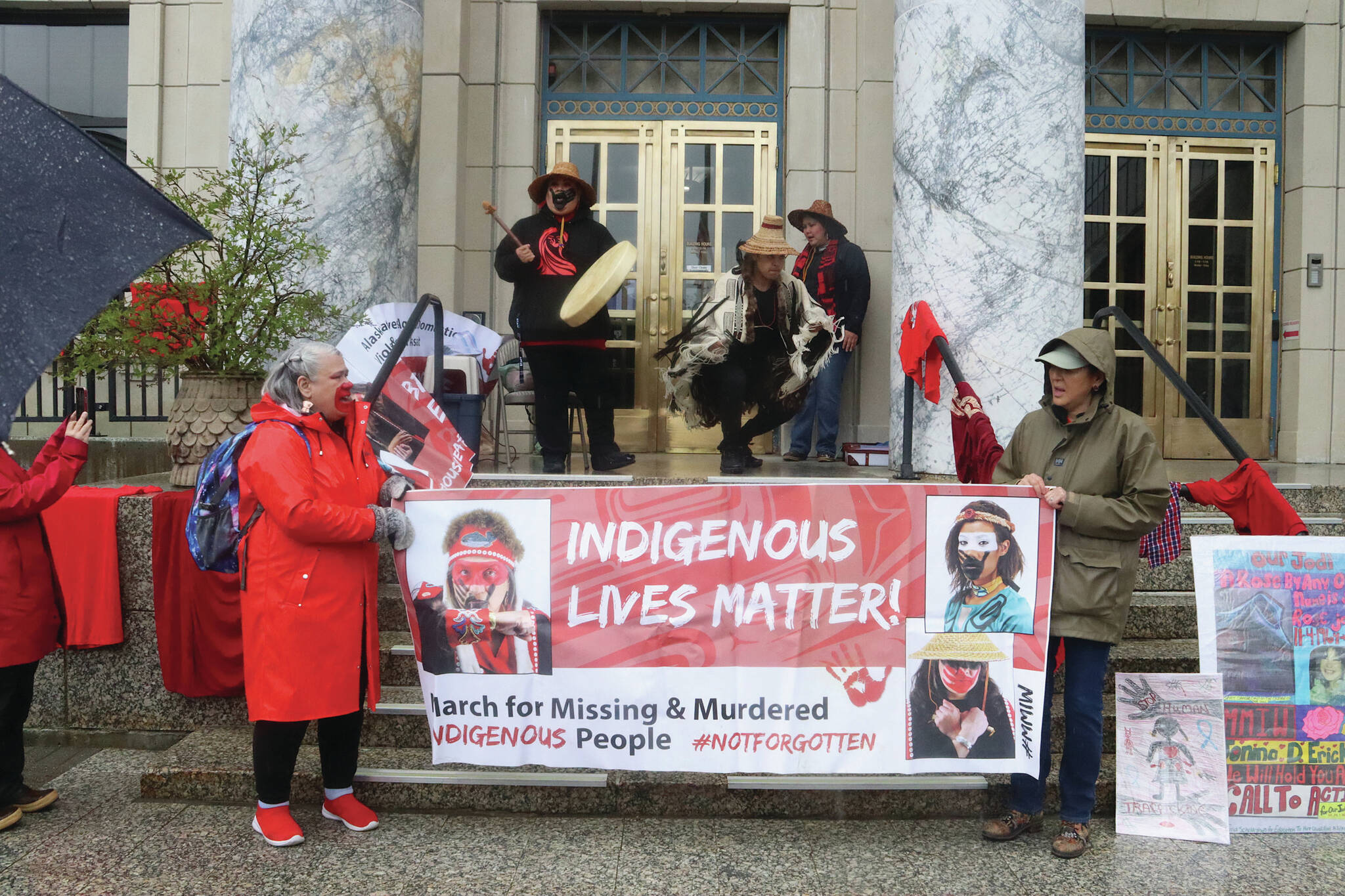 Mark Sabbatini / Juneau Empire
Advocates on behalf of missing and murdered Indigenous persons hold a banner and perform a opening song during a rally in front of the Alaska State Capitol on Sunday to commemorate the annual Missing and Murdered Indigenous Persons Awareness Day.