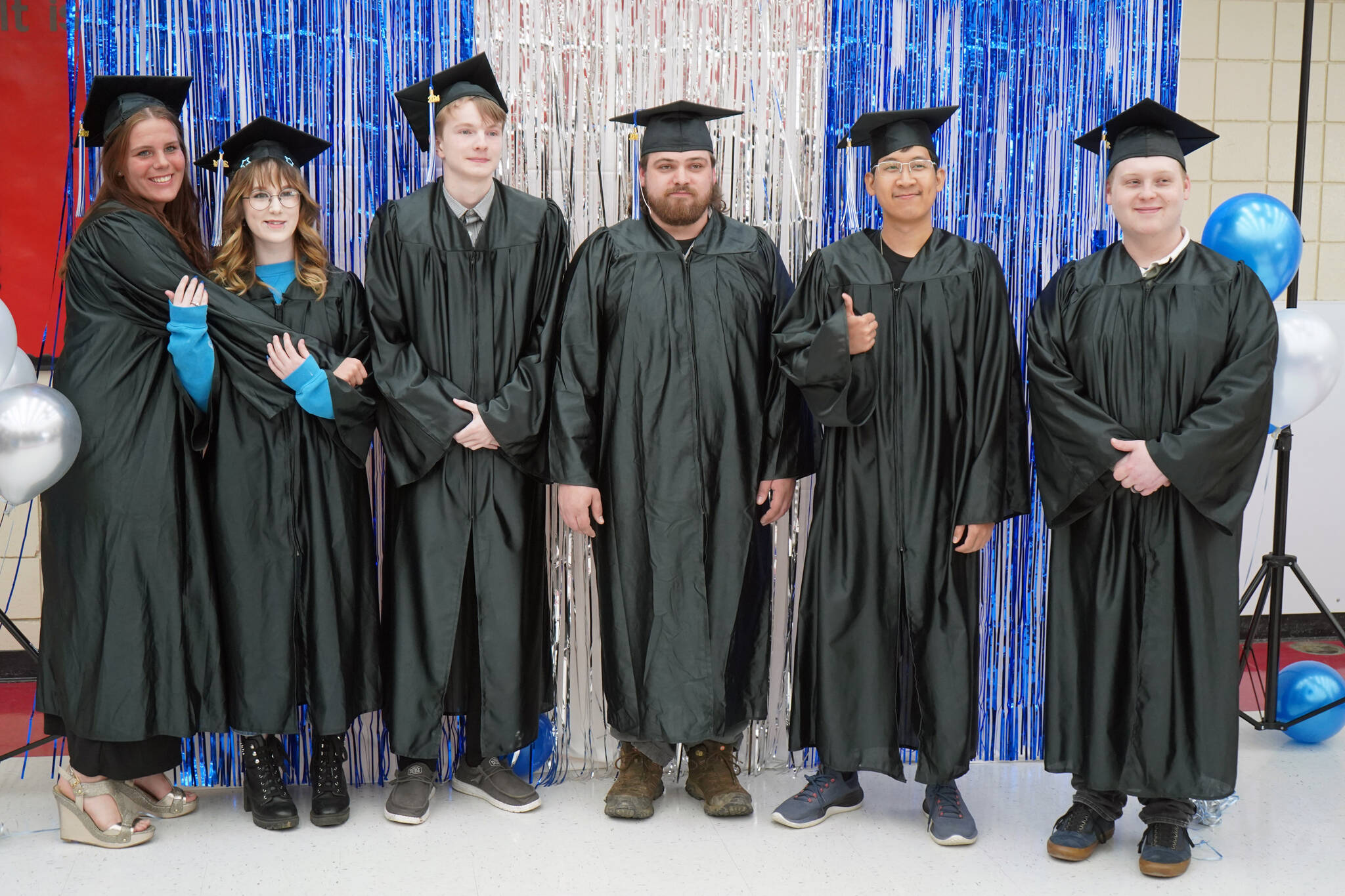 Graduates of Kenai Peninsula College gather for photos before the 54th Annual Kenai Peninsula College Commencement Ceremony at Kenai Central High School in Kenai, Alaska, on Thursday, May 9, 2024. (Jake Dye/Peninsula Clarion)