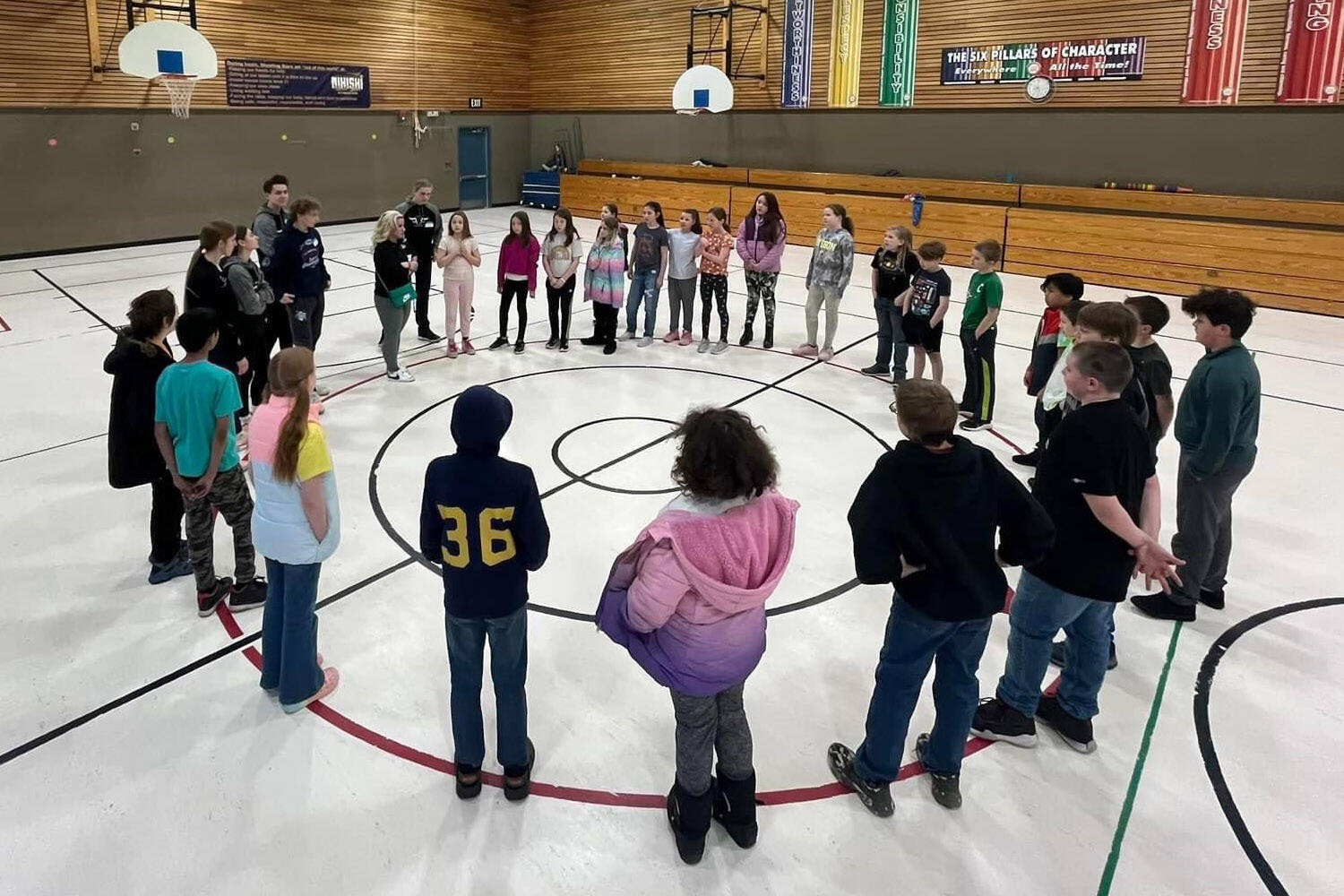 Athletes from Nikiski Middle/High School’s track and field team visit with elementary students at Nikiski North Star Elementary School in Nikiski, Alaska. (Photo provided)