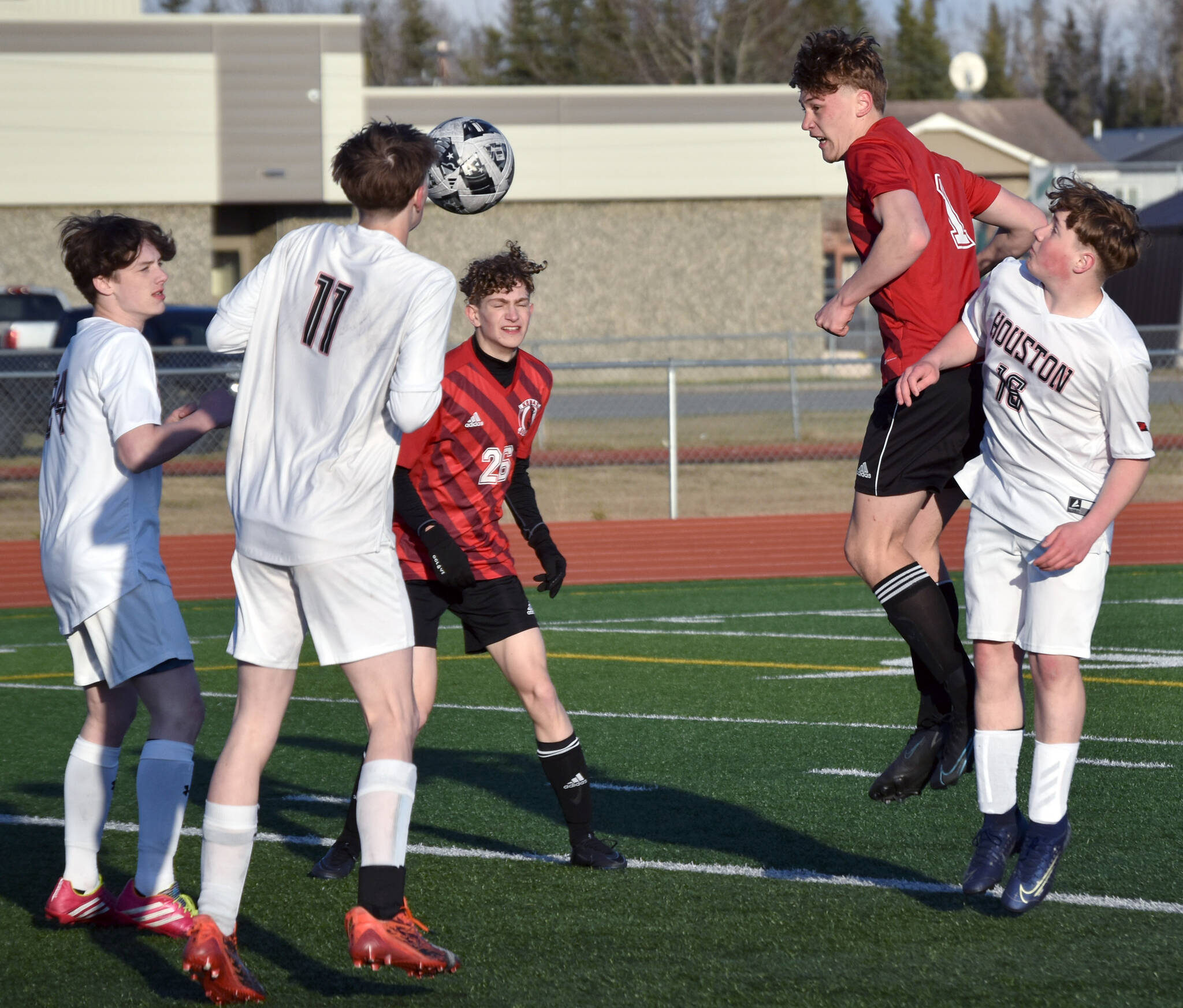 Kenai Central’s Ryker Dykema heads in a corner kick for a goal Thursday, May 9, 2024, at Kenai Central High School in Kenai, Alaska. (Photo by Jeff Helminiak/Peninsula Clarion)