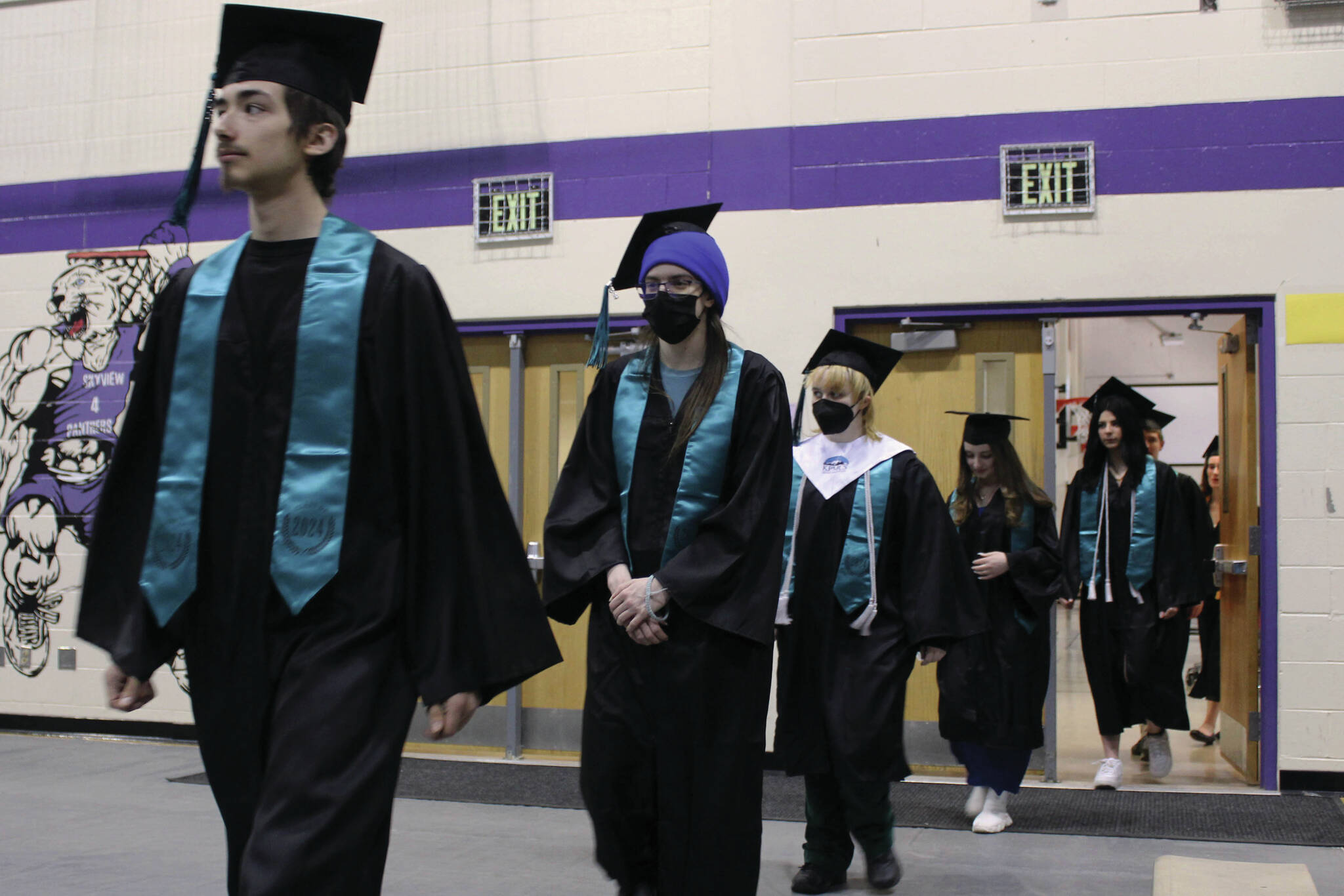 River City Academy graduates walk into Skyview Middle School’s gymnasium during their commencement ceremony on Monday near Soldotna. (Ashlyn O’Hara/Peninsula Clarion)