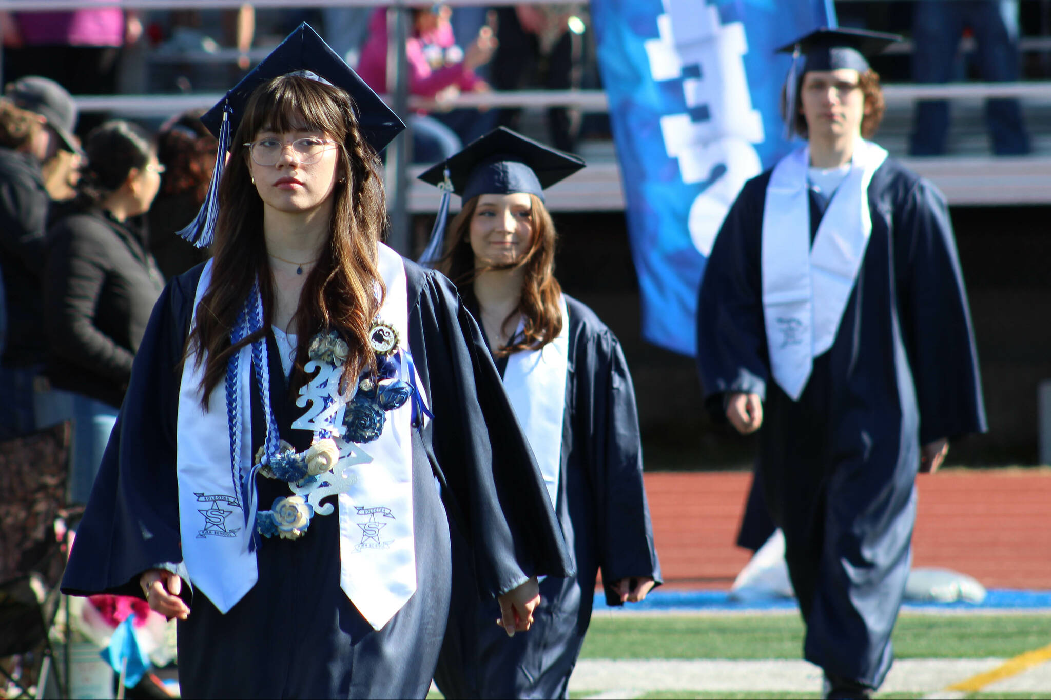 Caitlin Babcock, left, and other graduates enter Soldotna High School’s commencement ceremony on Tuesday, May 14, 2024, in Soldotna, Alaska. (Ashlyn O’Hara/Peninsula Clarion)